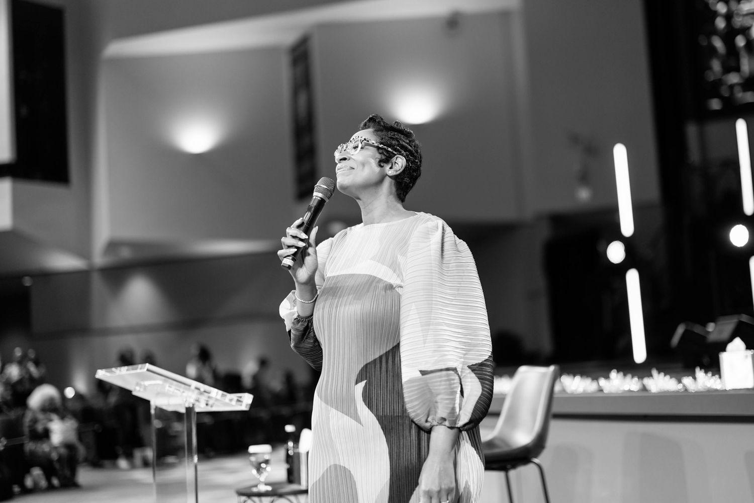 Black and white event photography showing stage and lighting setup.