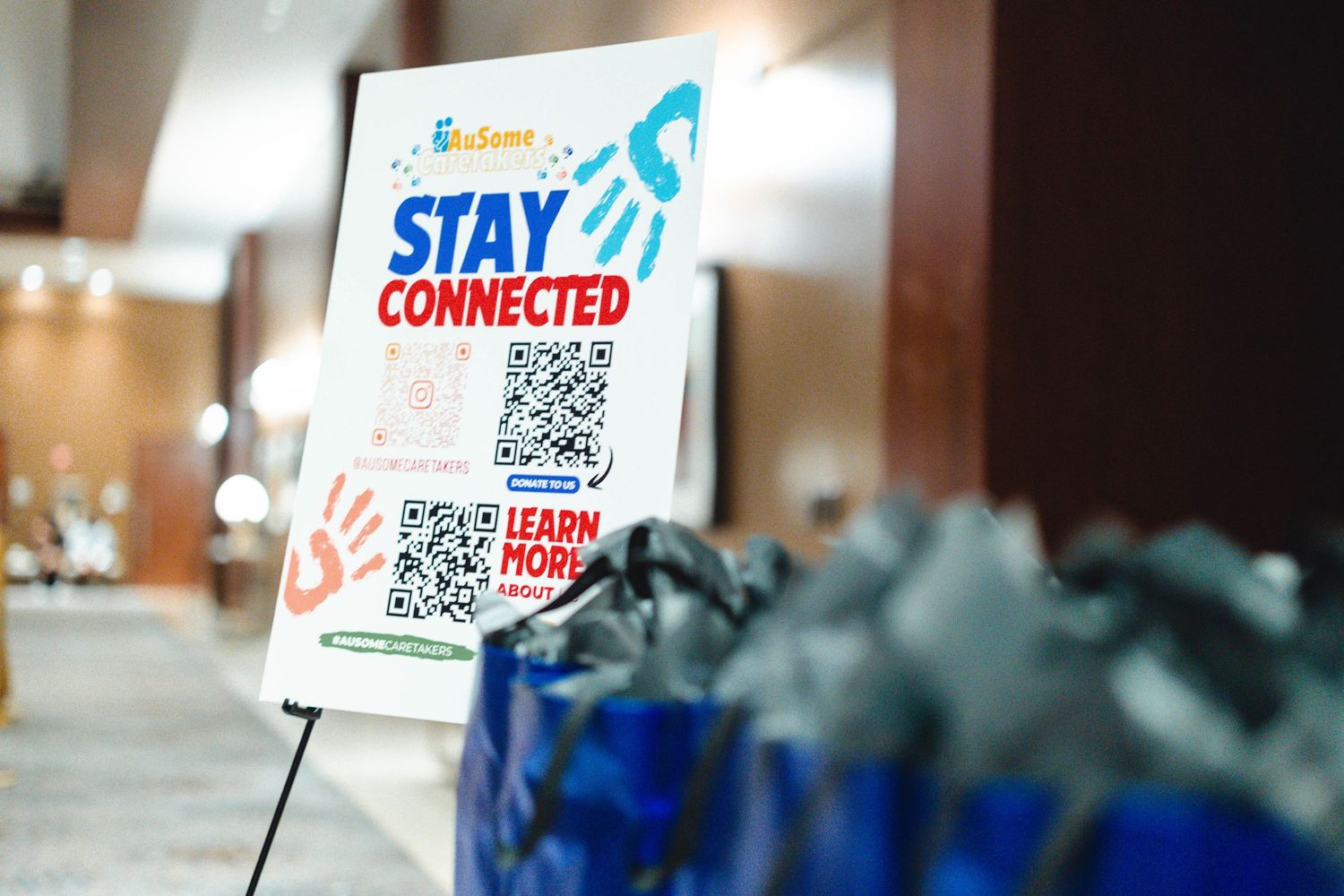 QR code signs with 'Stay Connected' text displayed at an event.