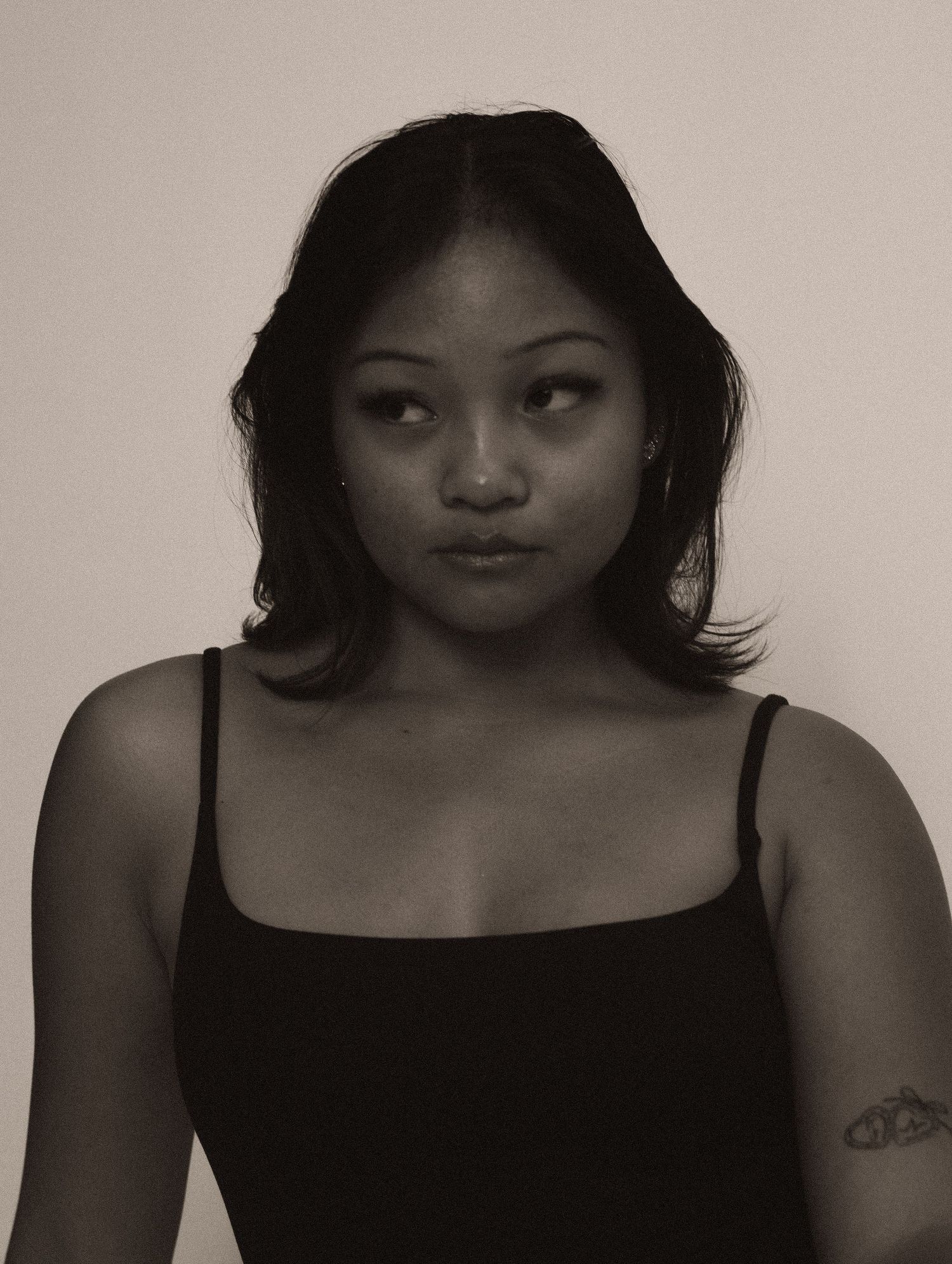 A black and white photo series showing different artistic poses and expressions in dramatic lighting.