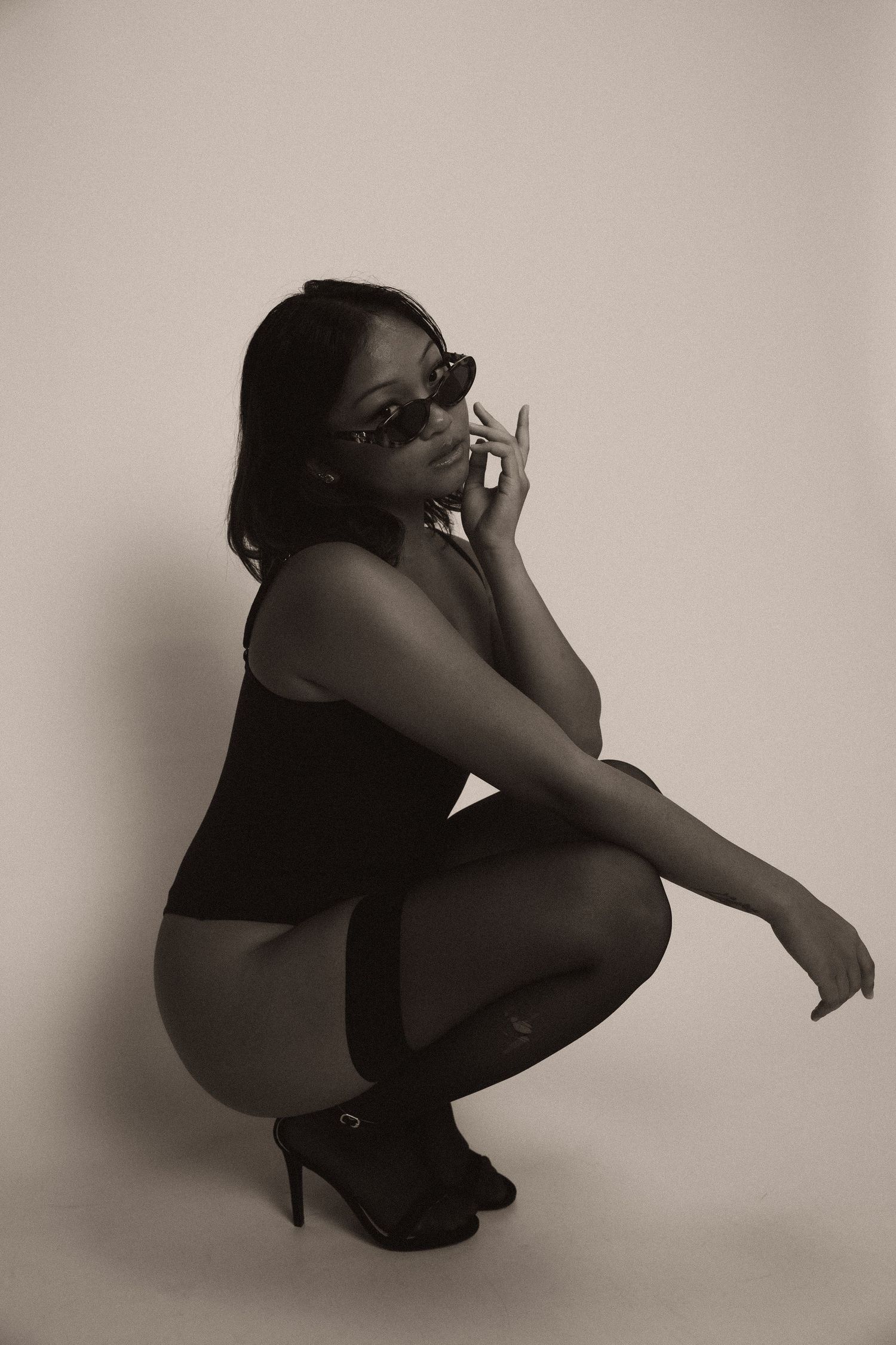 A series of black and white photos showing a figure crouched in different emotional poses against a plain wall.