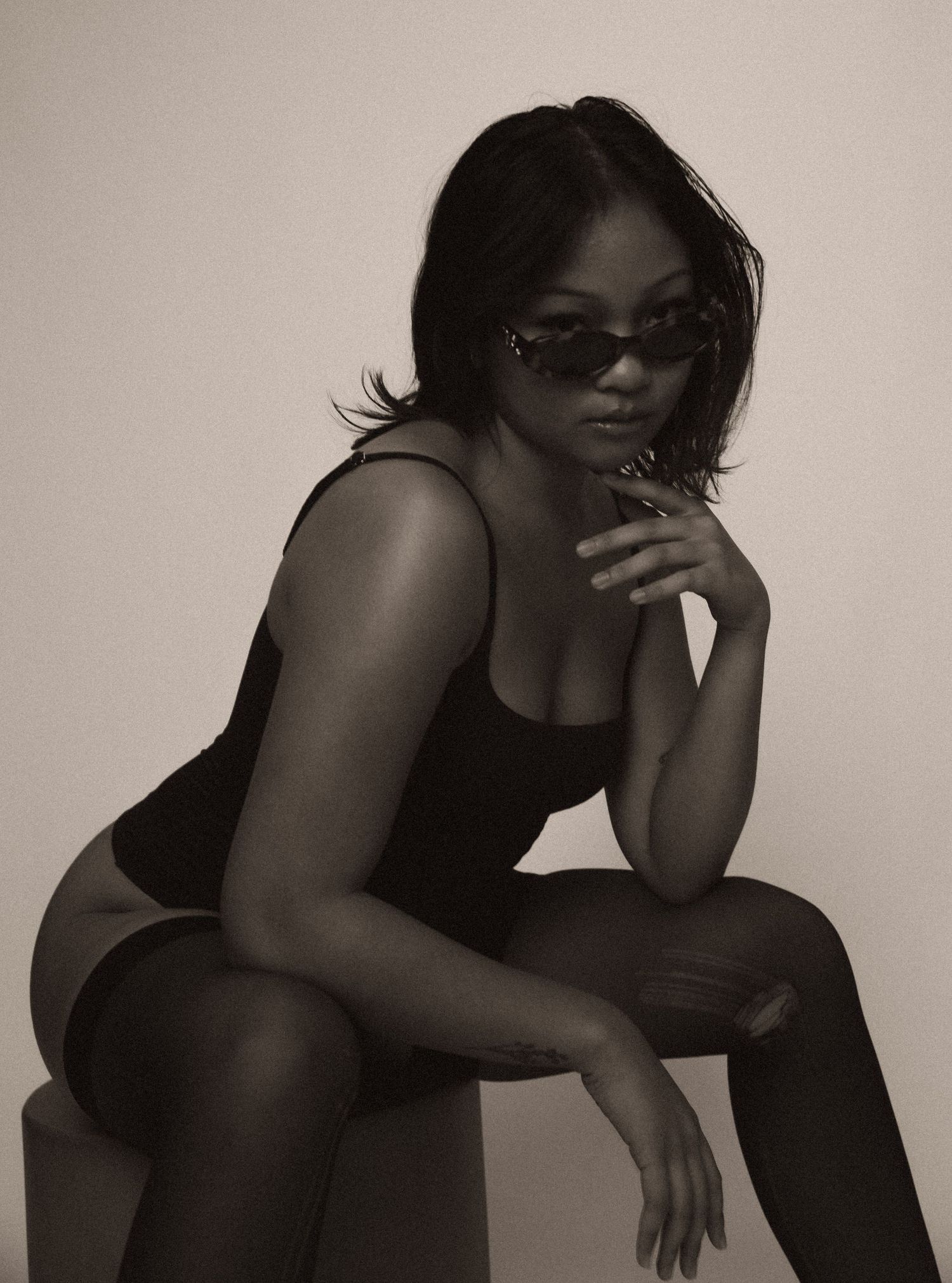 Artistic black and white portrait series showing a figure in dramatic poses against a neutral background.