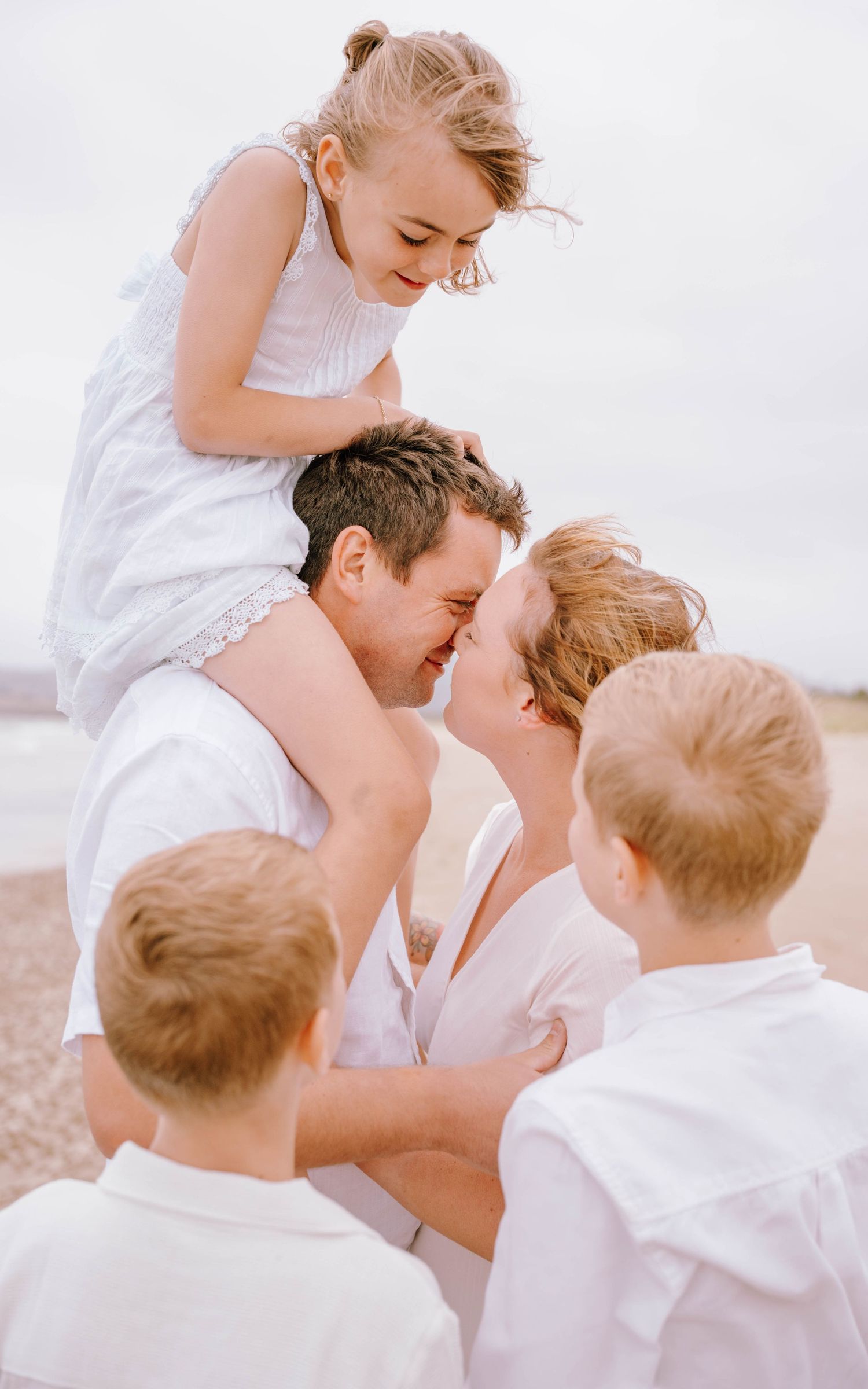 A romantic series of photos showing a couple in white clothing embracing and sharing intimate moments outdoors.