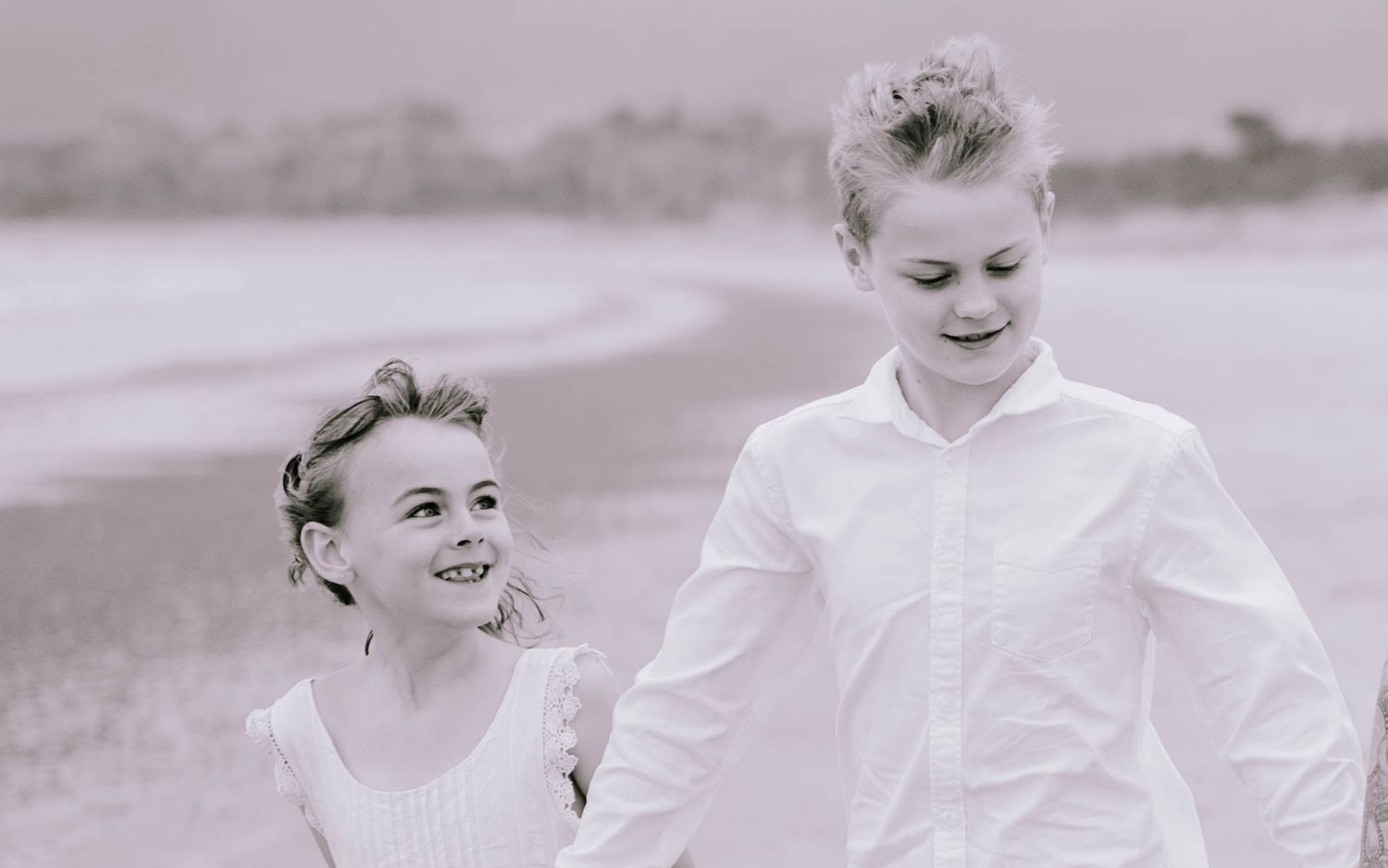A series of candid black and white wedding photos showing joyful moments between a couple in formal attire.