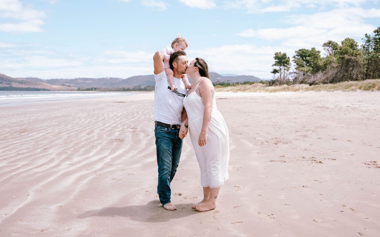 A romantic beach photoshoot sequence shows figures walking and embracing on a sandy shoreline at sunset.