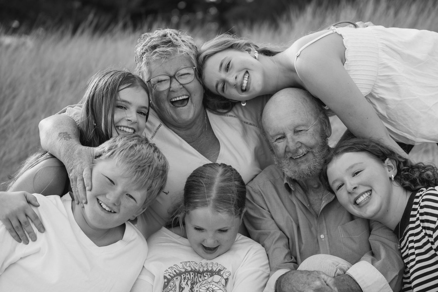 Black and white collage of family photos showing joyful moments and embraces together.