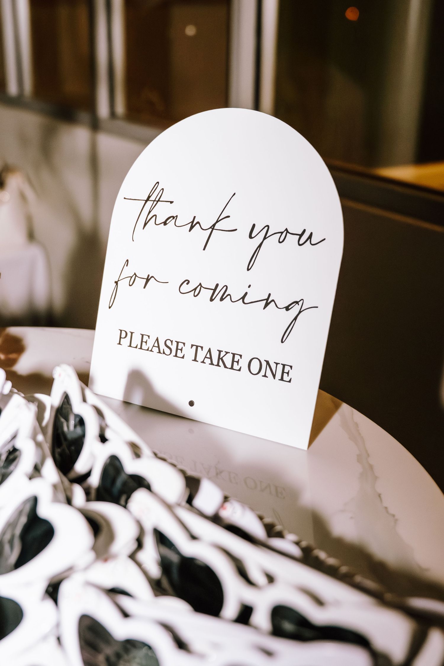 Wedding favor table with white sunglasses and a thank you sign saying please take one.