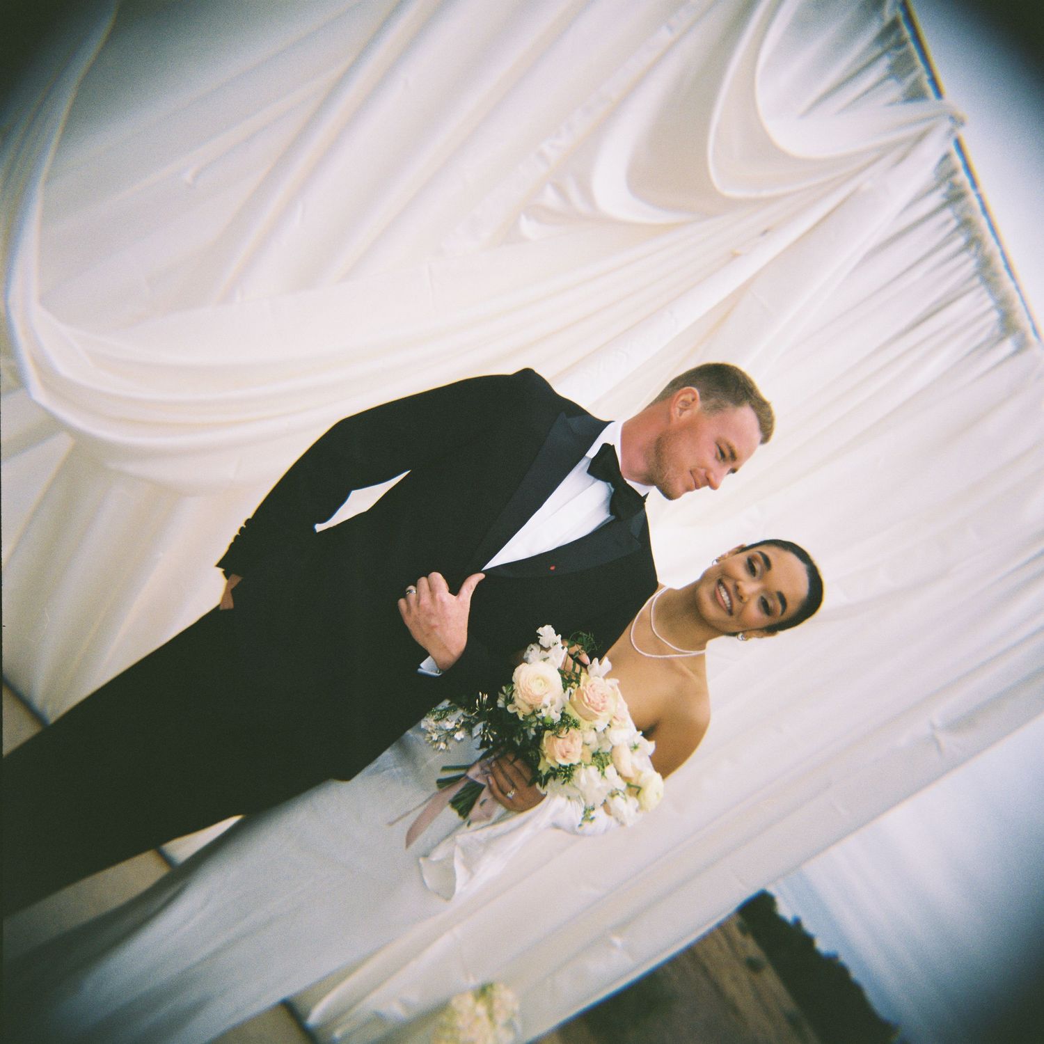 High-end luxury editorial photograph of bride and groom at the altar, drapery installed by Premiere Events in Austin, Texas film photo
