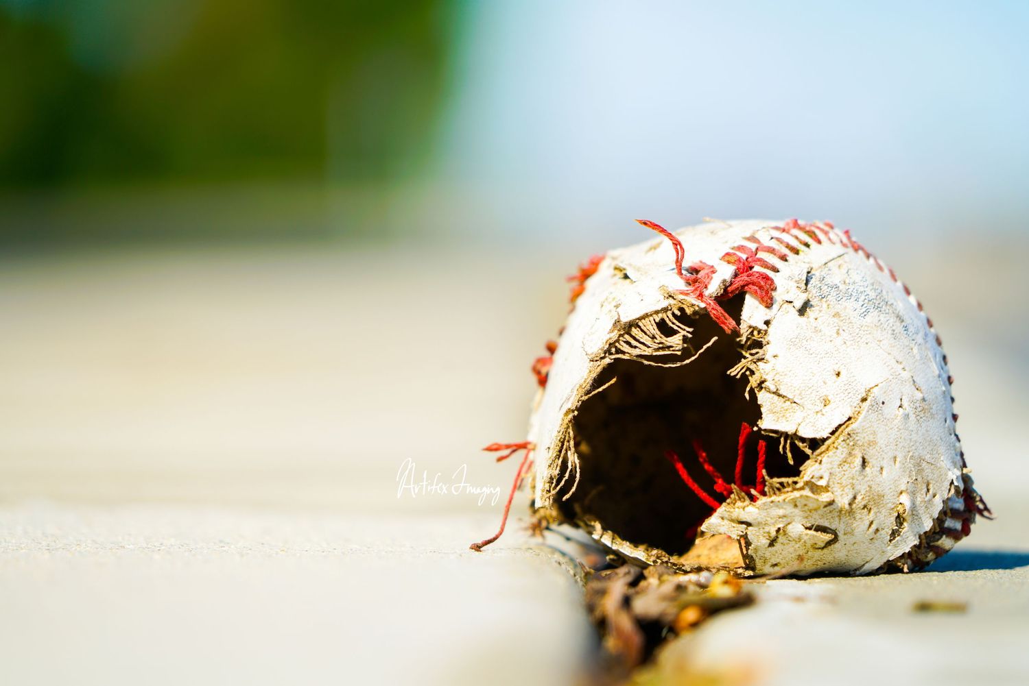 California Love series; image featuring a torn and abandoned baseball taken by Artifex Imaging in Bakersfield, CA.