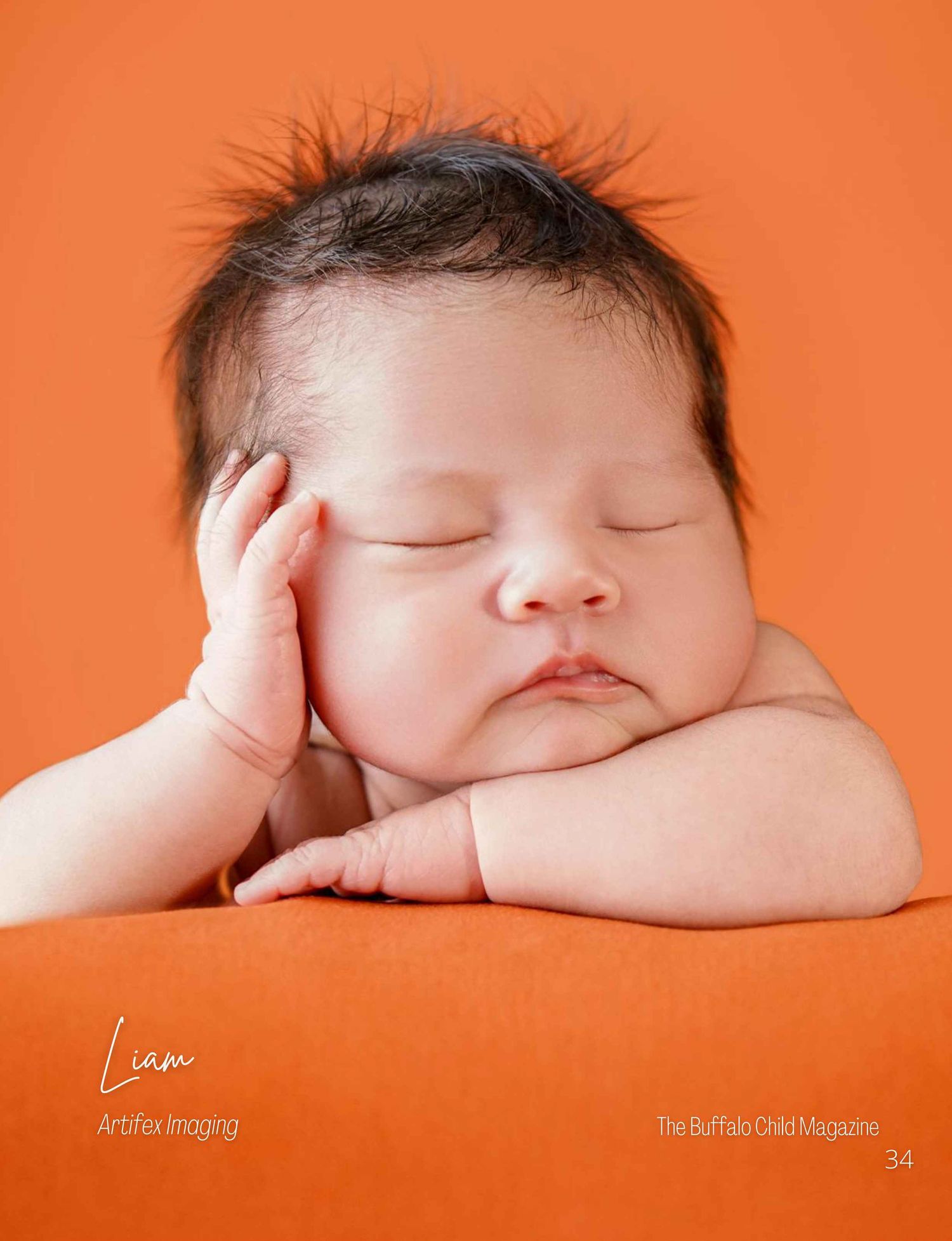 Buffalo Child Magazine feature of a sleeping infant propped up on his elbows taken by Artifex Imaging in Bakersfield, CA.