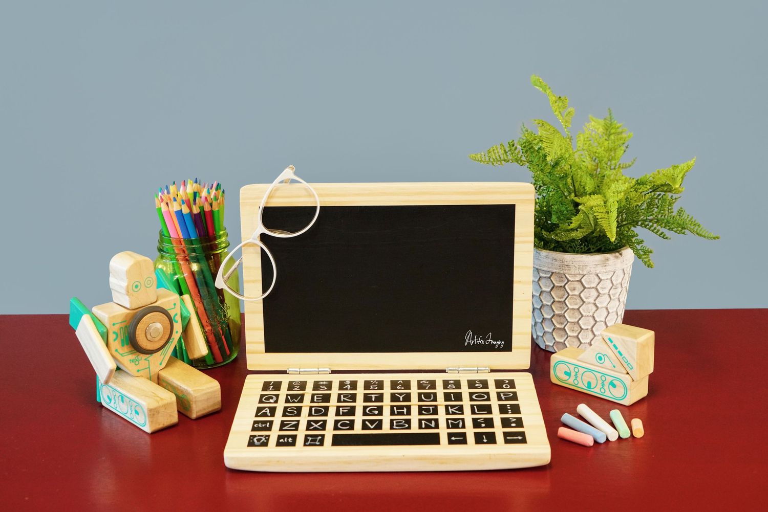 Creative commercial image of a hand-made wooden laptop toy taken by Artifex Imaging in Bakersfield, CA. for Etsy shop SomewhereStrange.