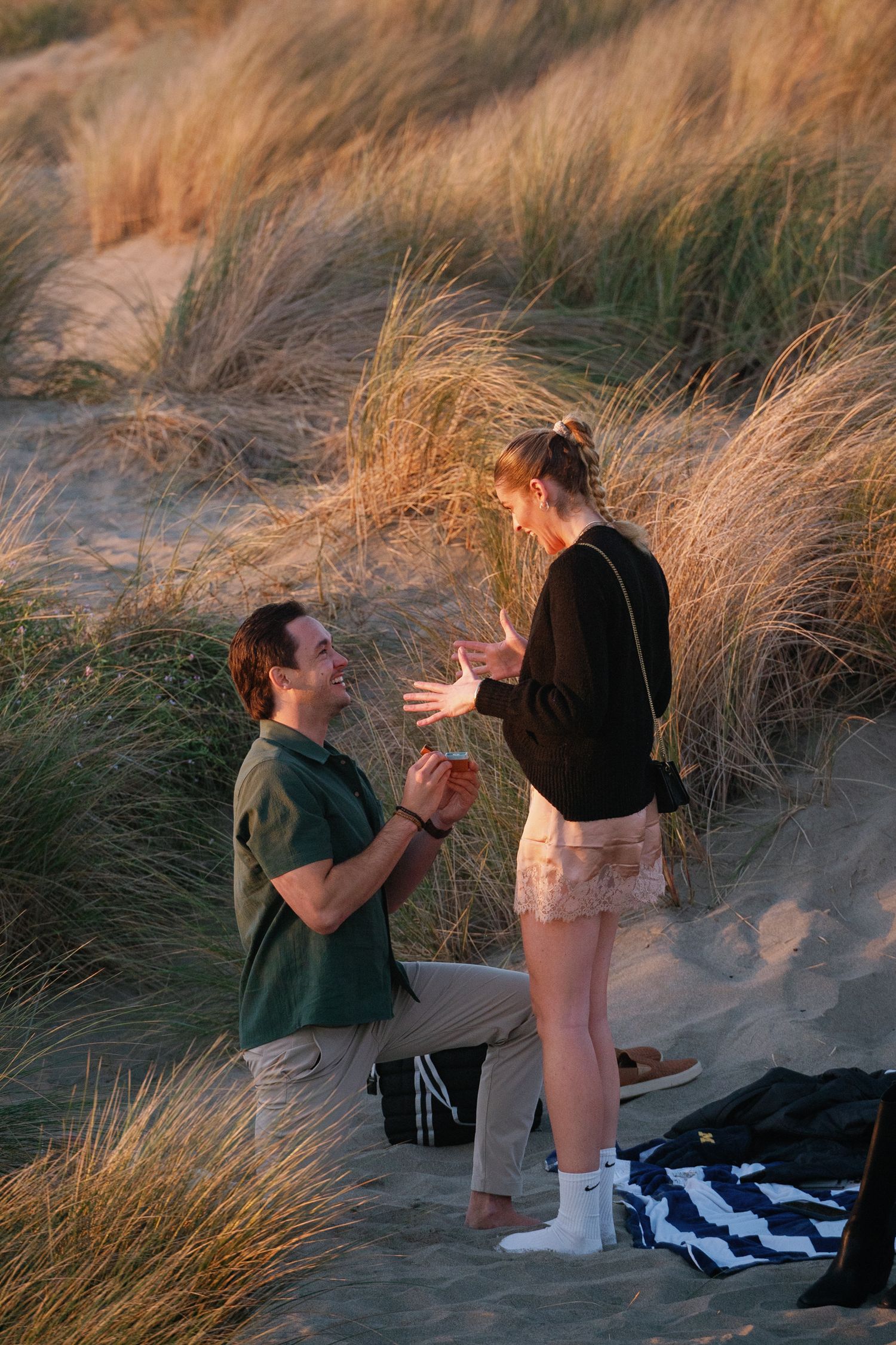 Marriage proposal sequence photographed at scenic beach location during golden hour.