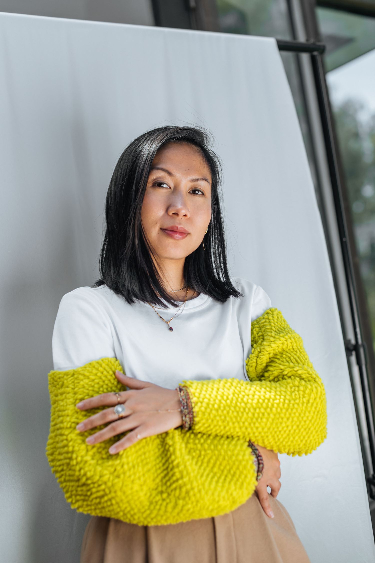 Modern portrait series featuring white top with chunky yellow knit sleeves.