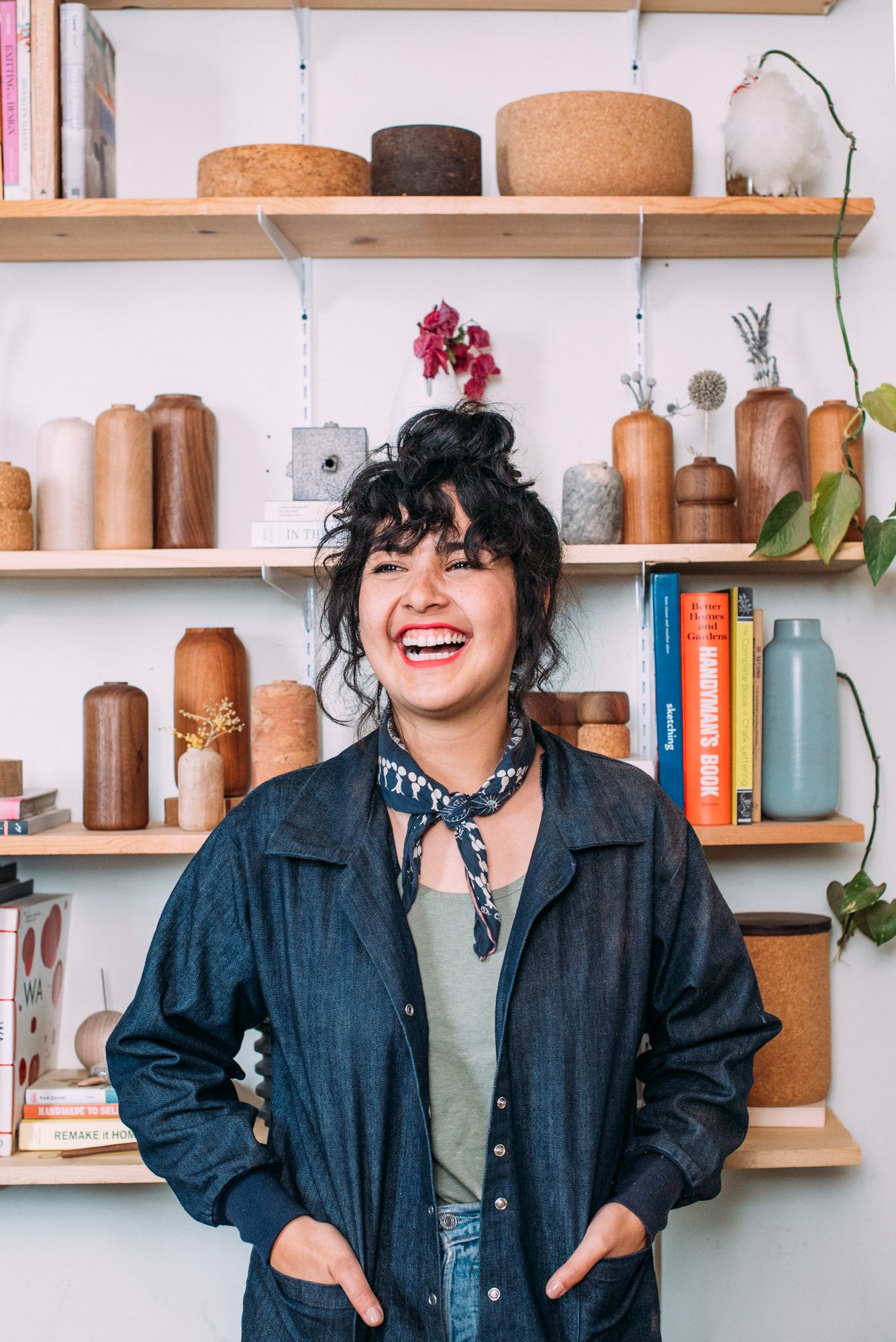 Candid lifestyle portraits against backdrop of wooden shelves with books and decor.