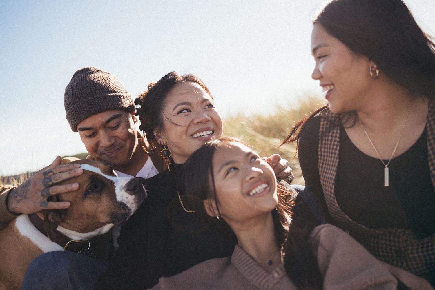 Close-up candid shots of loving embraces and laughter during sunset.