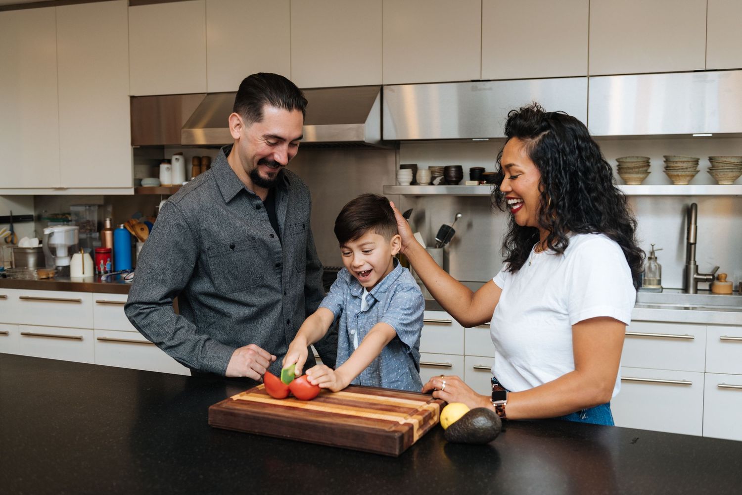 Family spending quality time together in a modern kitchen while preparing food.
