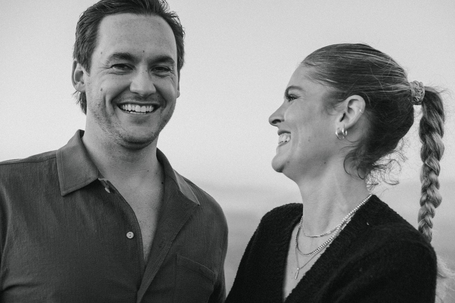 Black and white portrait series showing a couple sharing intimate laughs together.
