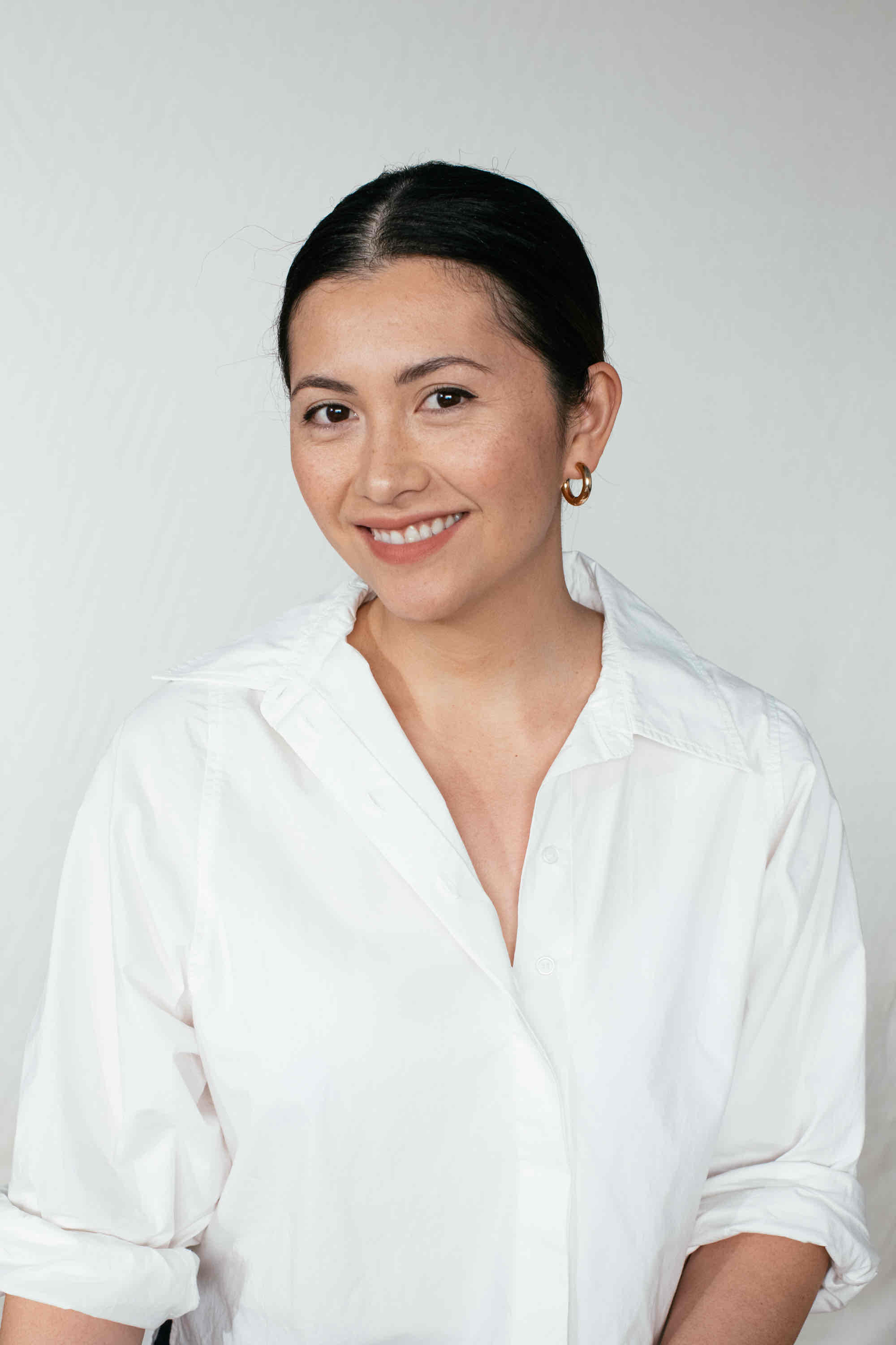A series of headshots showing someone wearing a white collared shirt against a light background.