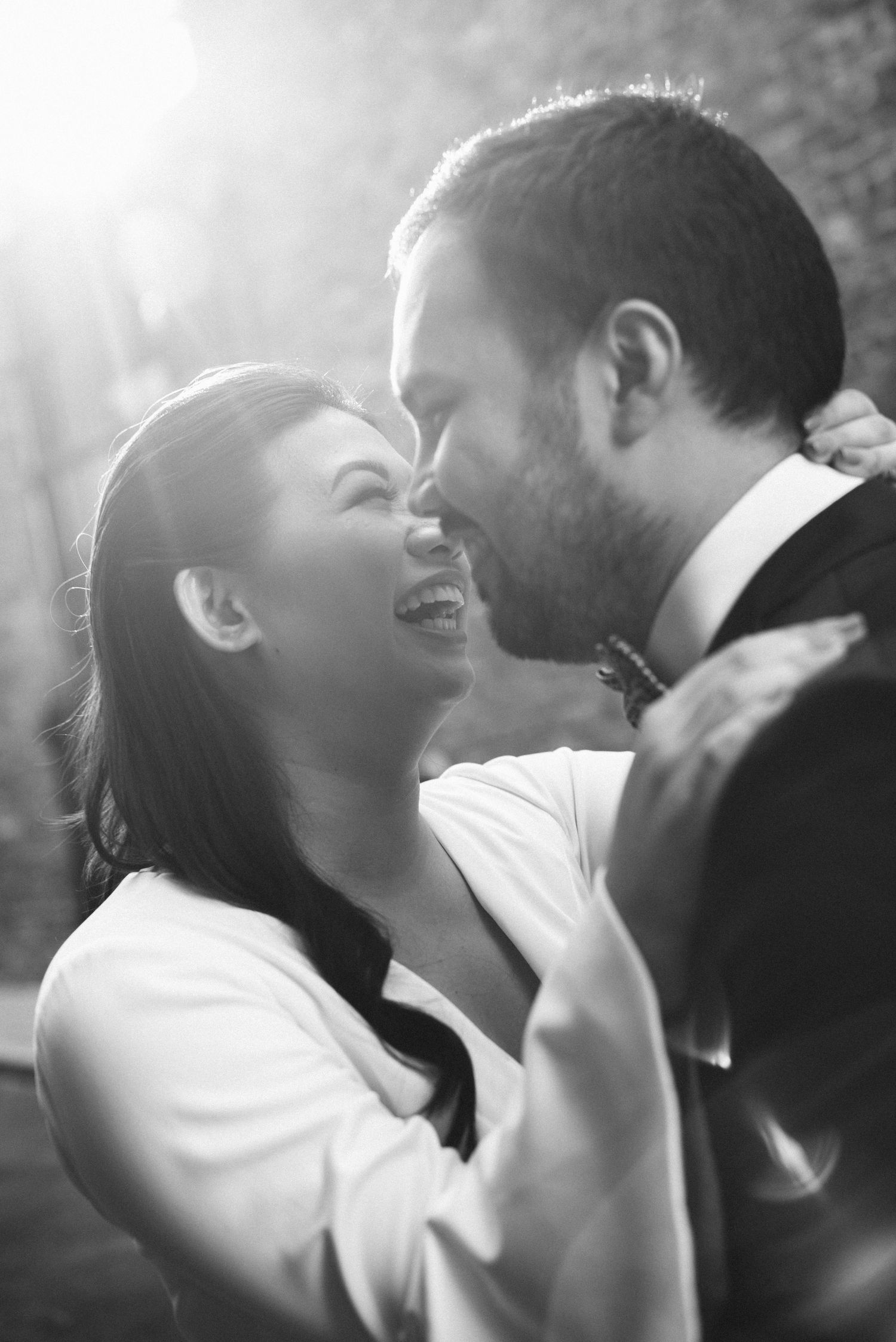 A romantic black and white photo sequence showing a couple sharing an intimate kiss in dramatic lighting.