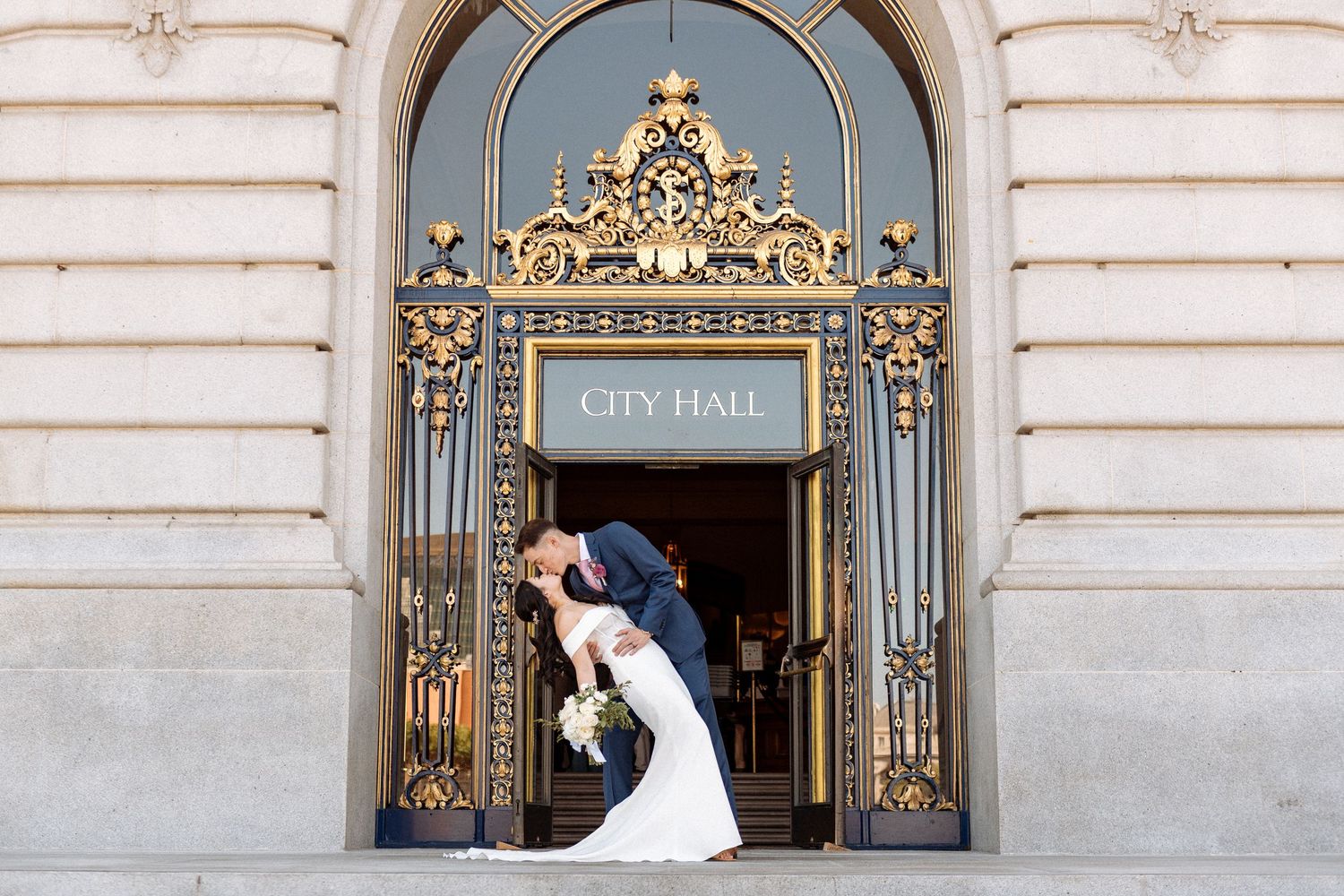 Elegant City Hall entrance with ornate gold details and classic architectural elements.