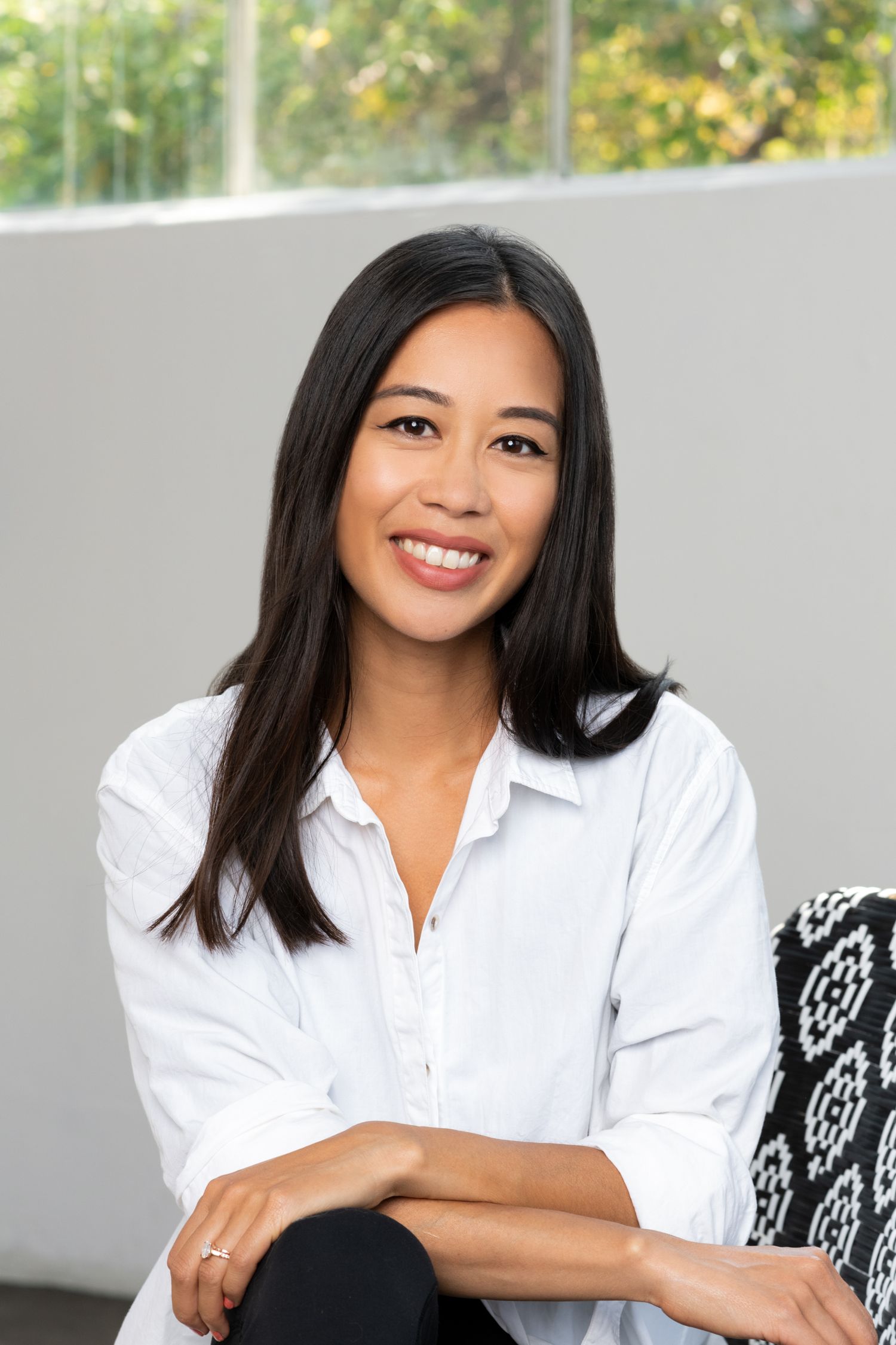Professional headshots in crisp white button-down shirt against neutral background.