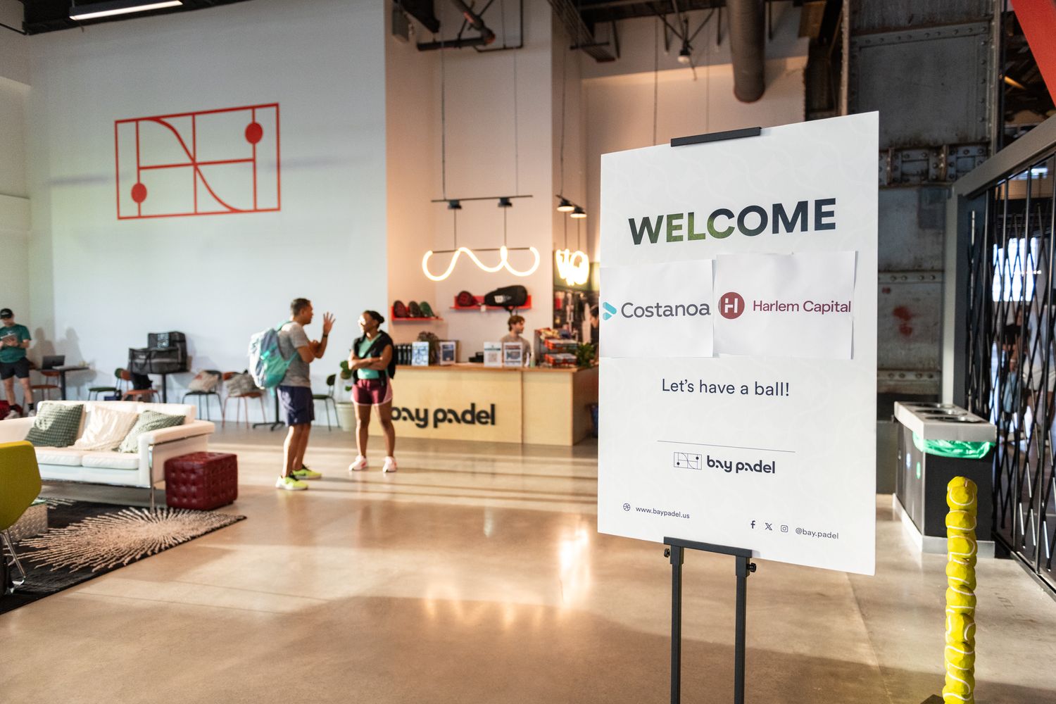 A modern office lobby space with white walls, welcome signage and minimalist design elements throughout the interior.