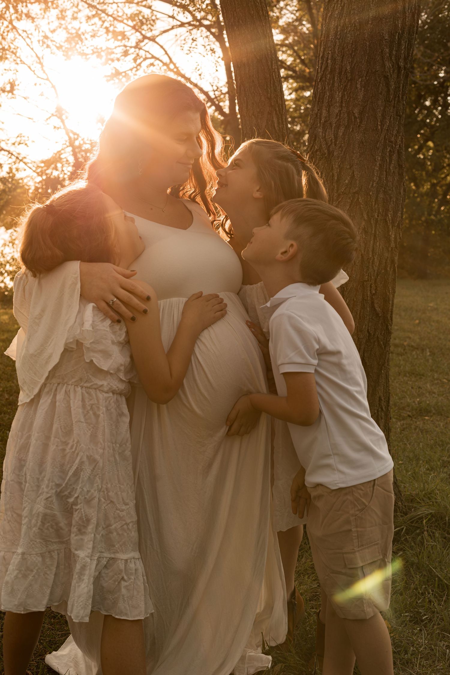 Family with young children enjoying a playful outdoor photography session during golden hour in Maryland.