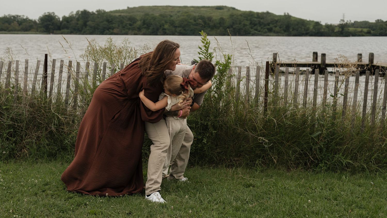 Mother, father and child sharing a sweet moment during an outdoor family photography session in Maryland.