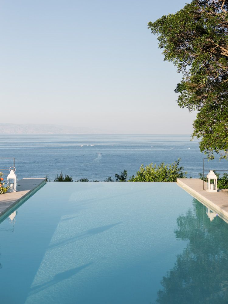 Luxury poolside view at Villa Mon Repos in Taormina, Sicily, overlooking the Mediterranean Sea.