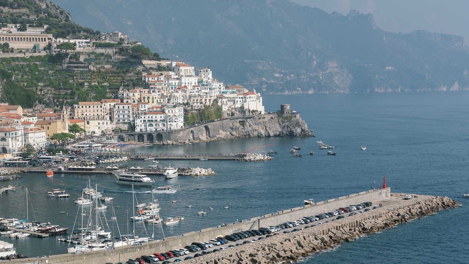 Scenic view of the Amalfi Coast in Italy with boats on the Mediterranean Sea along the iconic coastline.