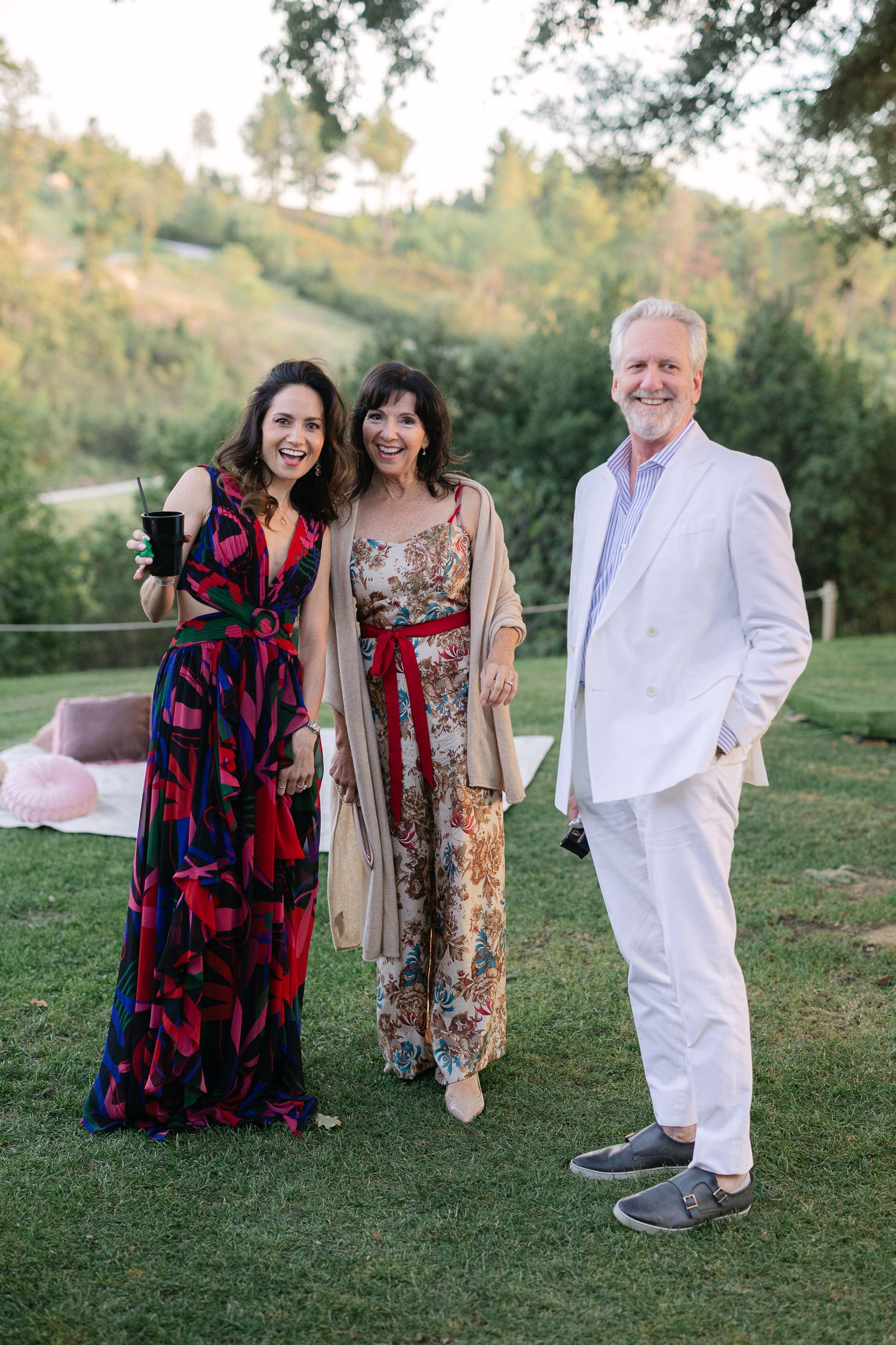 Wedding guests smiling and hugging during a joyful multi-day celebration in Sicily, capturing candid moments of love and connection.