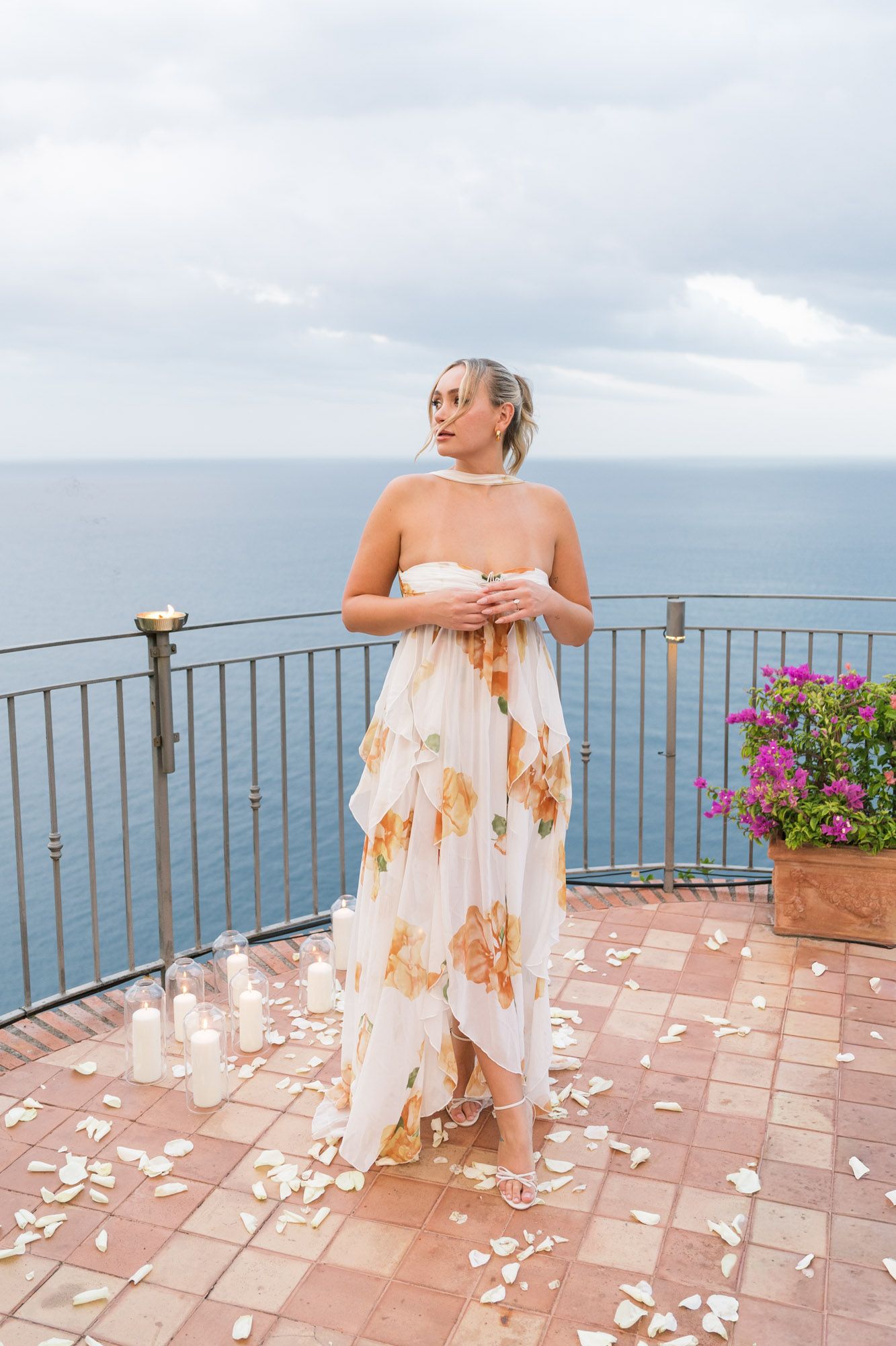 Bride showing engagement ring on balcony at Hotel San Pietro, Taormina, overlooking the sea.