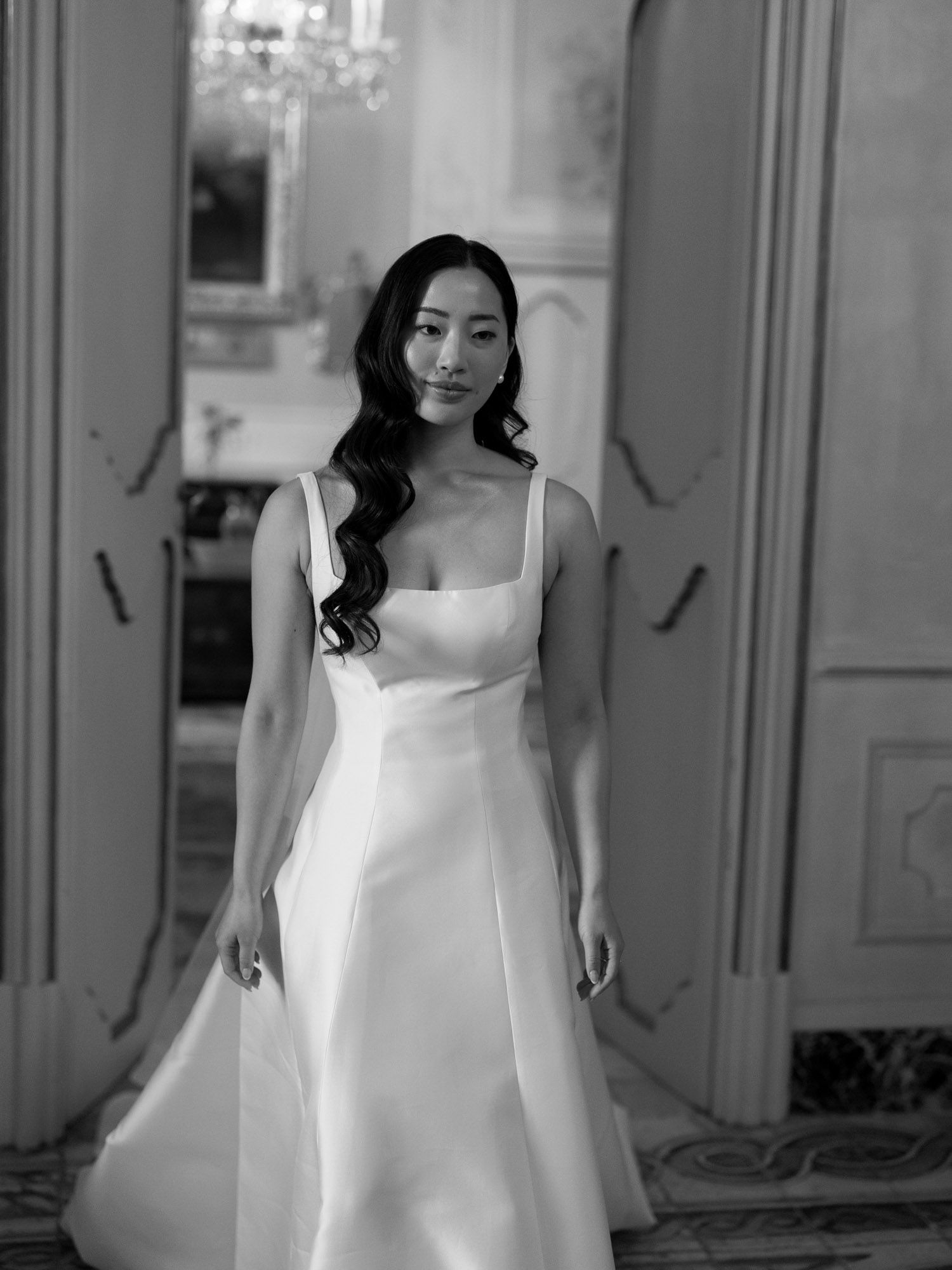 Editorial black-and-white portrait of a bride walking inside Villa Tasca in Palermo, elegant destination wedding setting in Sicily.