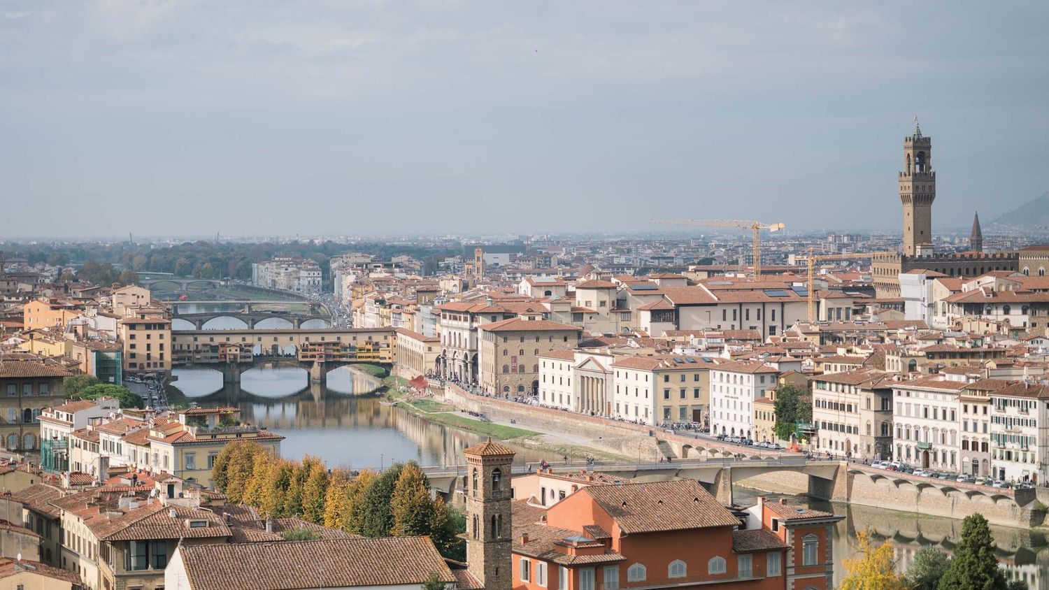 Aerial view of Ponte Vecchio and Florence skyline, editorial cityscape photography.