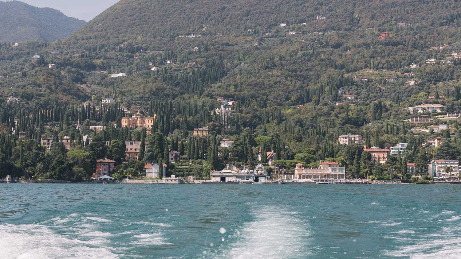 Scenic view of Isola del Garda from boat, editorial destination wedding perspective.