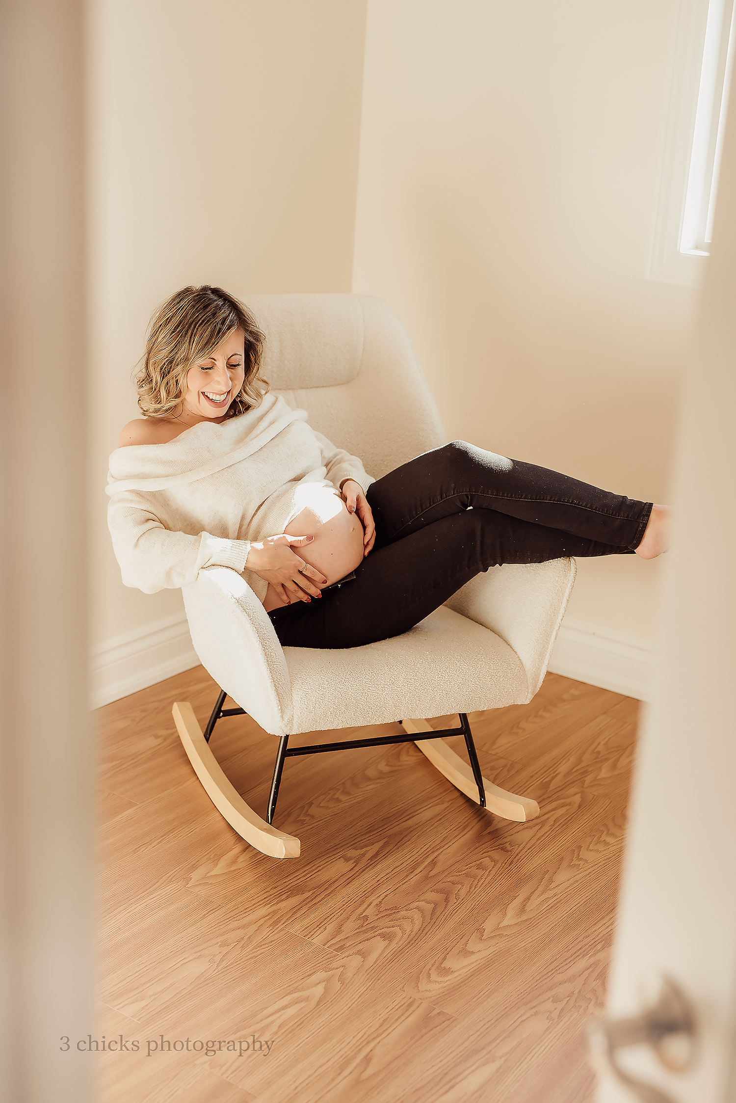 relax in a rocking chair during a maternity shoot.