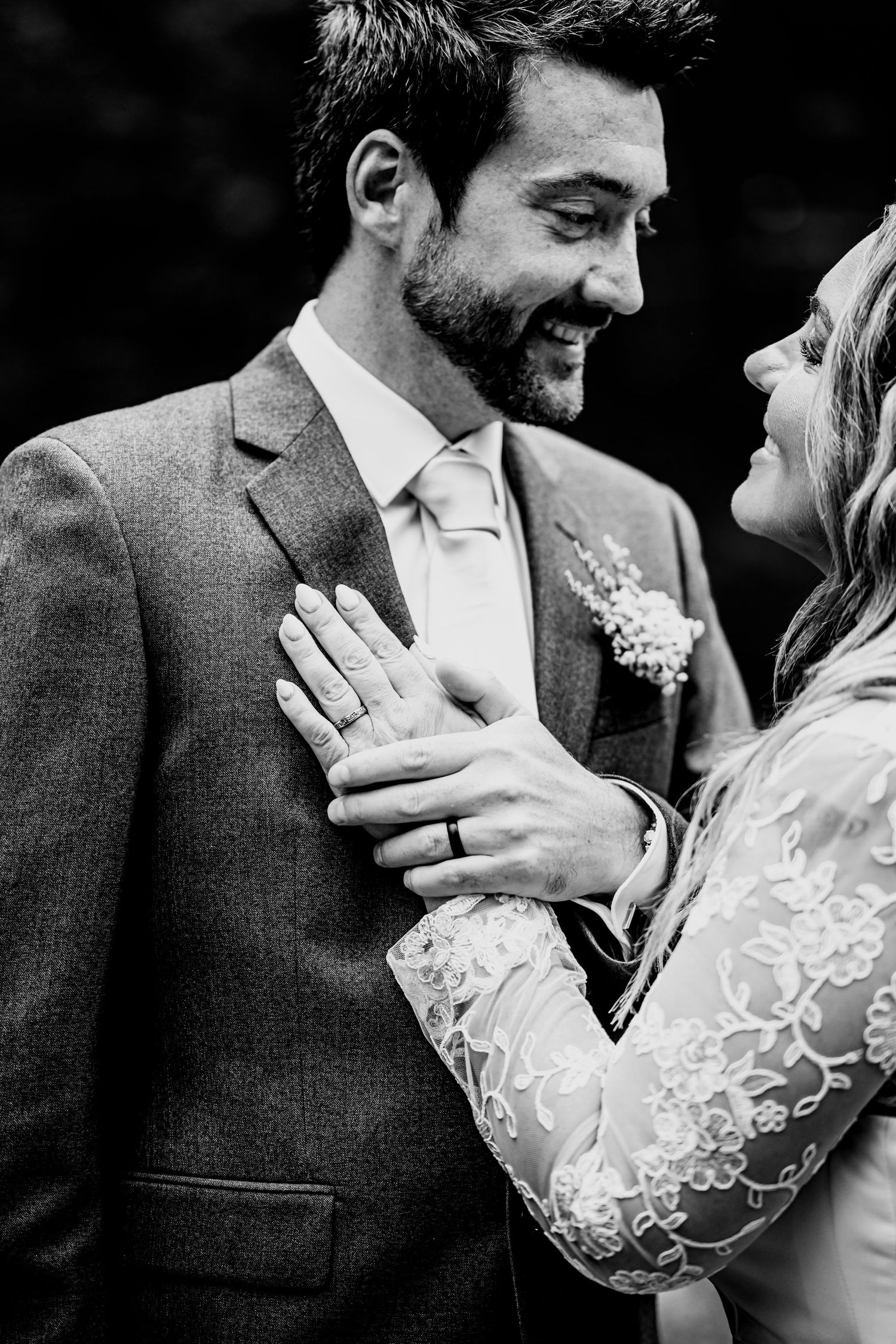 Intimate black and white close-up of a tender moment between newlyweds.