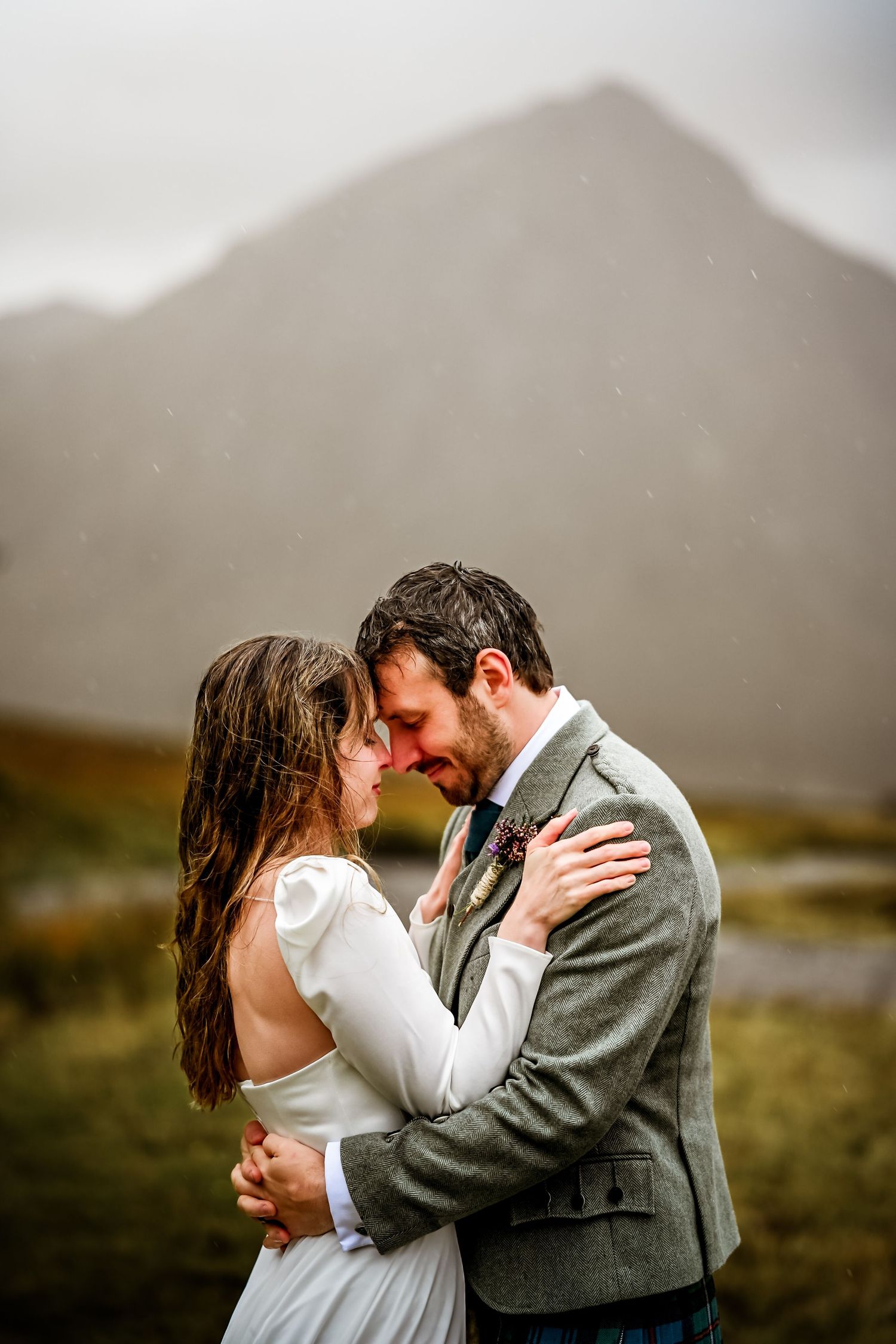A romantic wedding photo shoot in a scenic mountain landscape with moody clouds. Kings House Hotel Wedding Photography