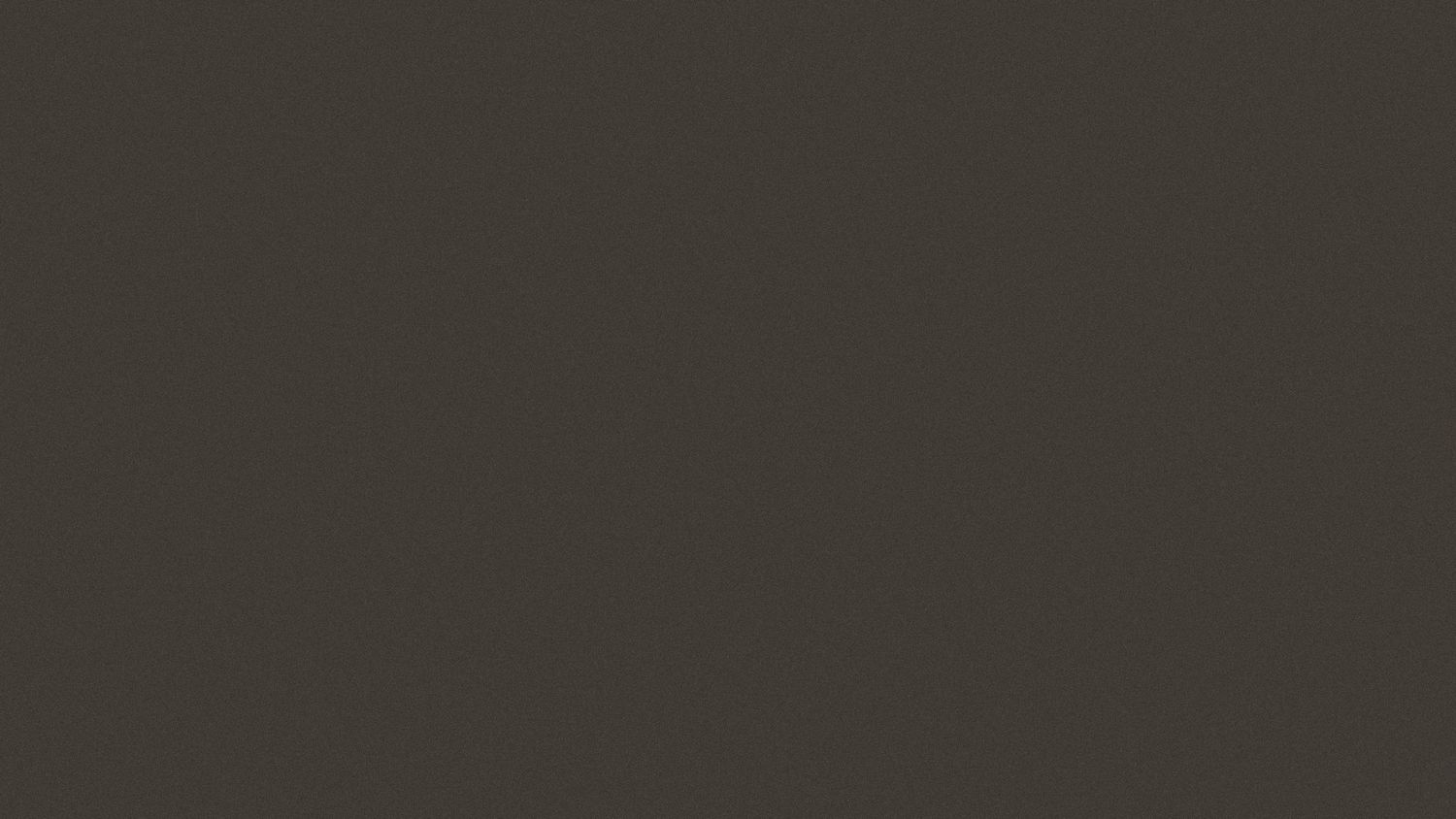 Dark charcoal gray smooth textured background surface.