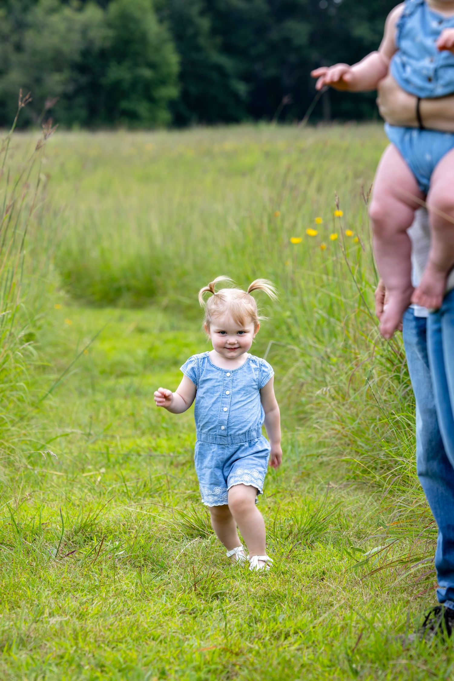 Sequence showing a child in blue playing and running through tall grass.