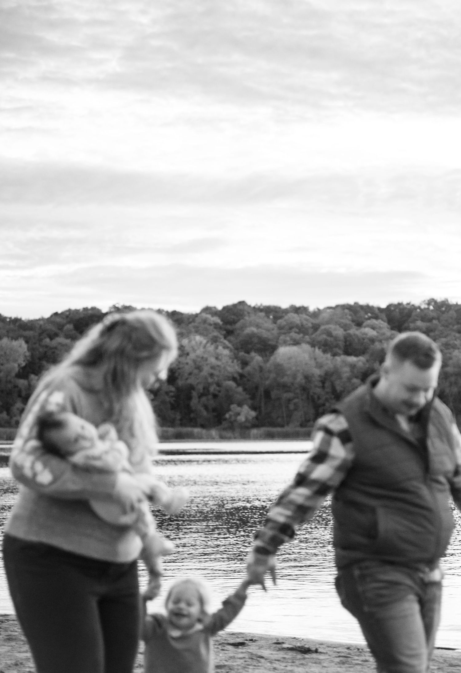 A series of playful black and white photos showing people interacting by a lake.