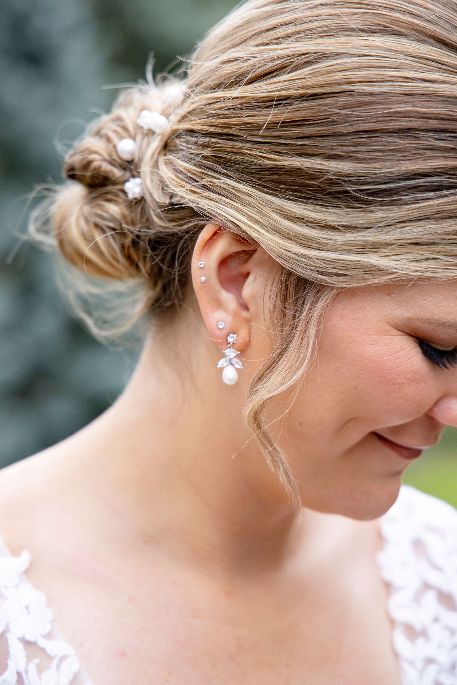 Close-up of elegant bridal hairstyle and crystal drop earring.