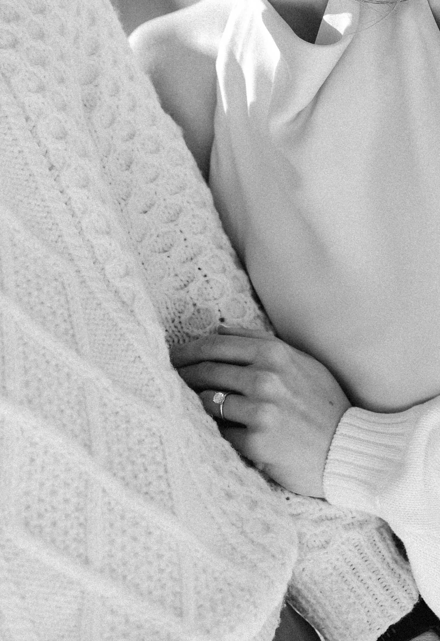 Black and white intimate portrait of couple in winter attire.