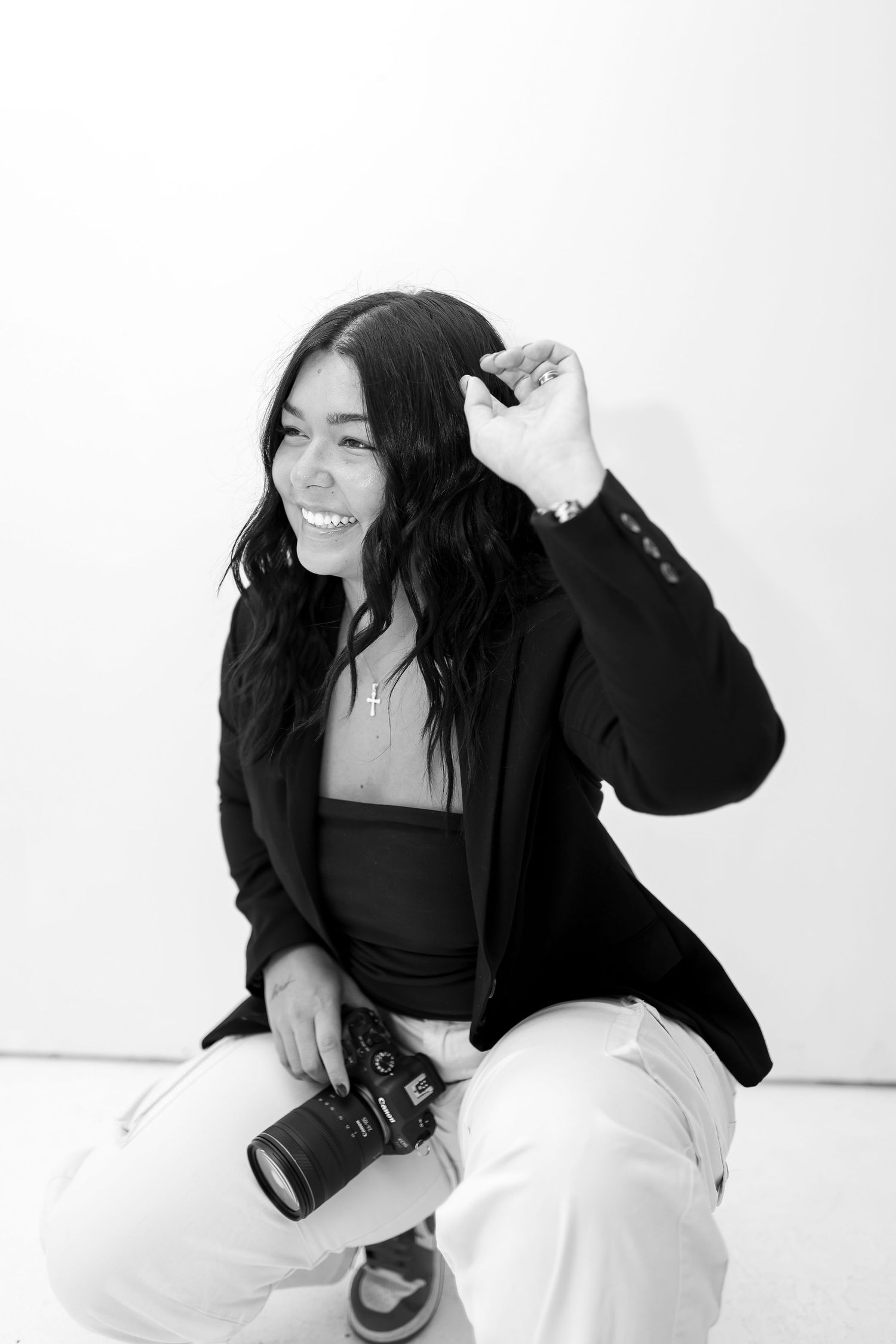 Black and white photography series showing playful poses against white backdrop.