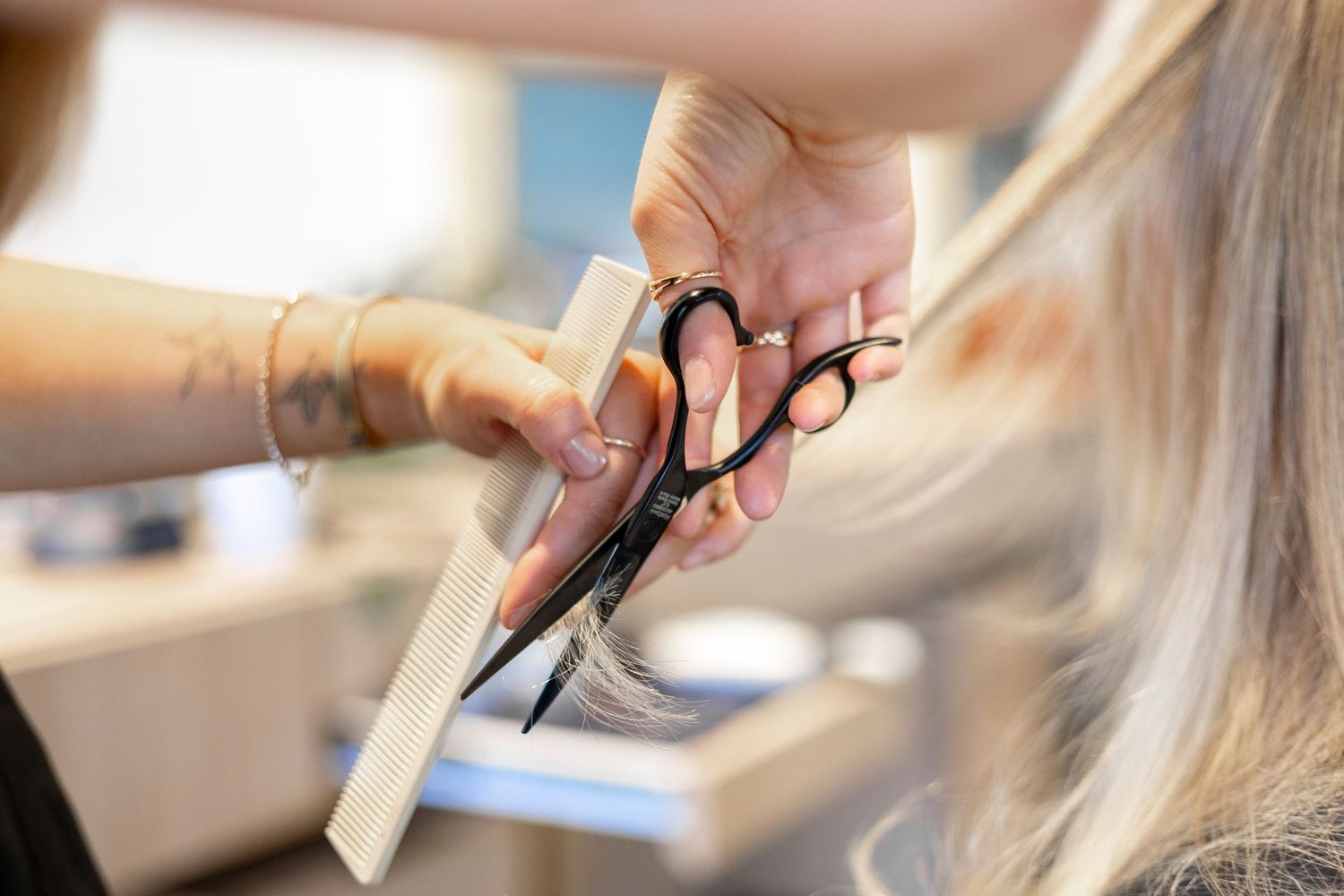 Close-up shots of hair being cut and styled in a salon.