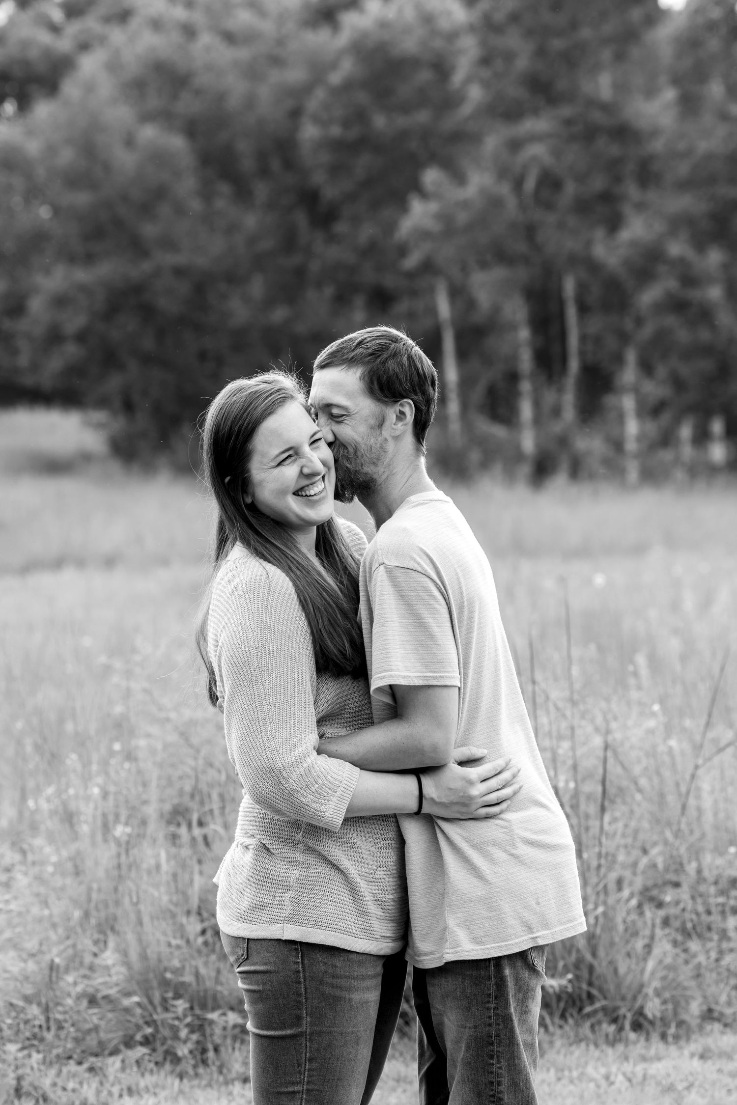 Black and white series of candid moments showing affection in a field.