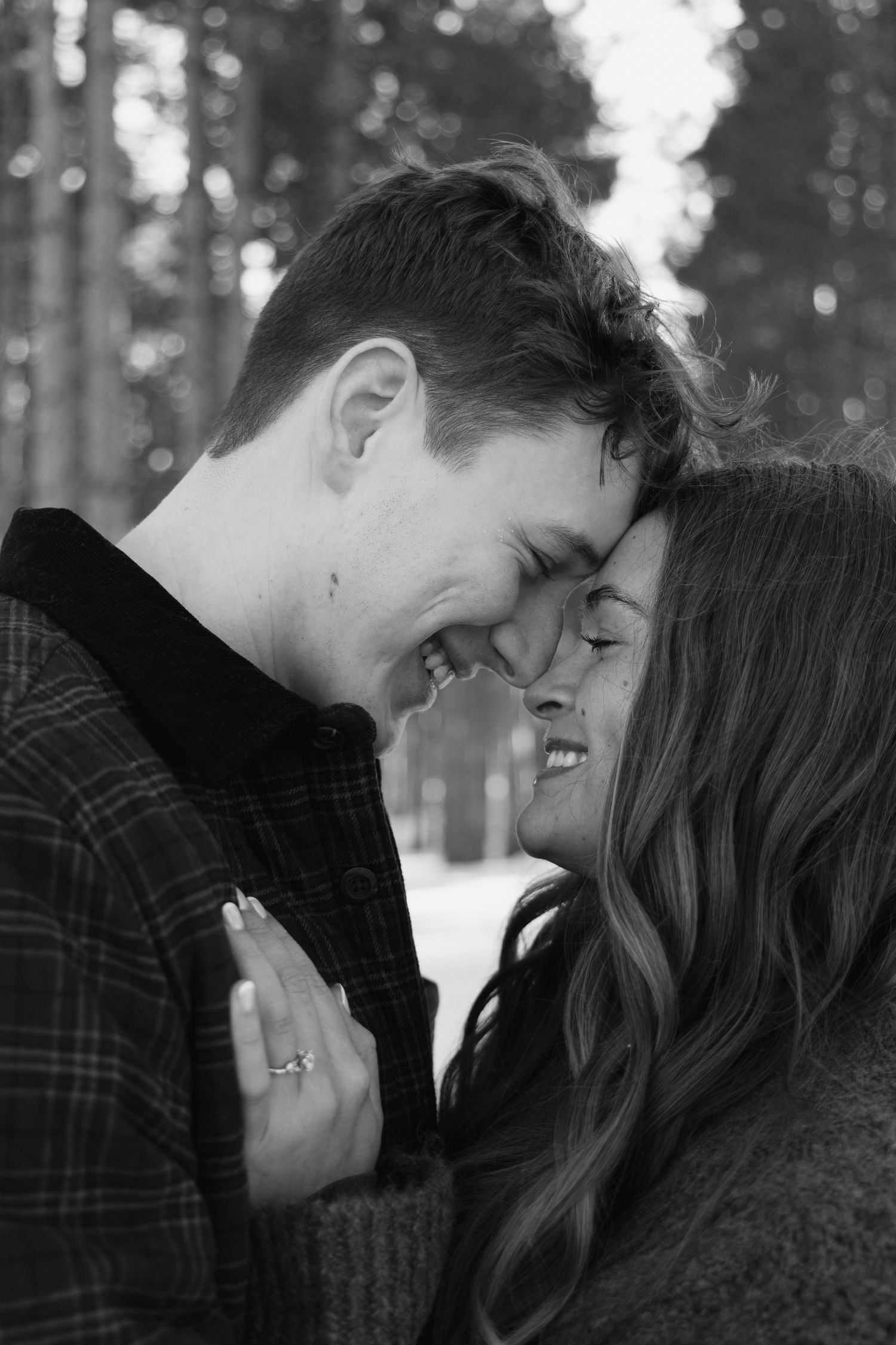 Intimate black and white portrait of a couple sharing a tender moment.