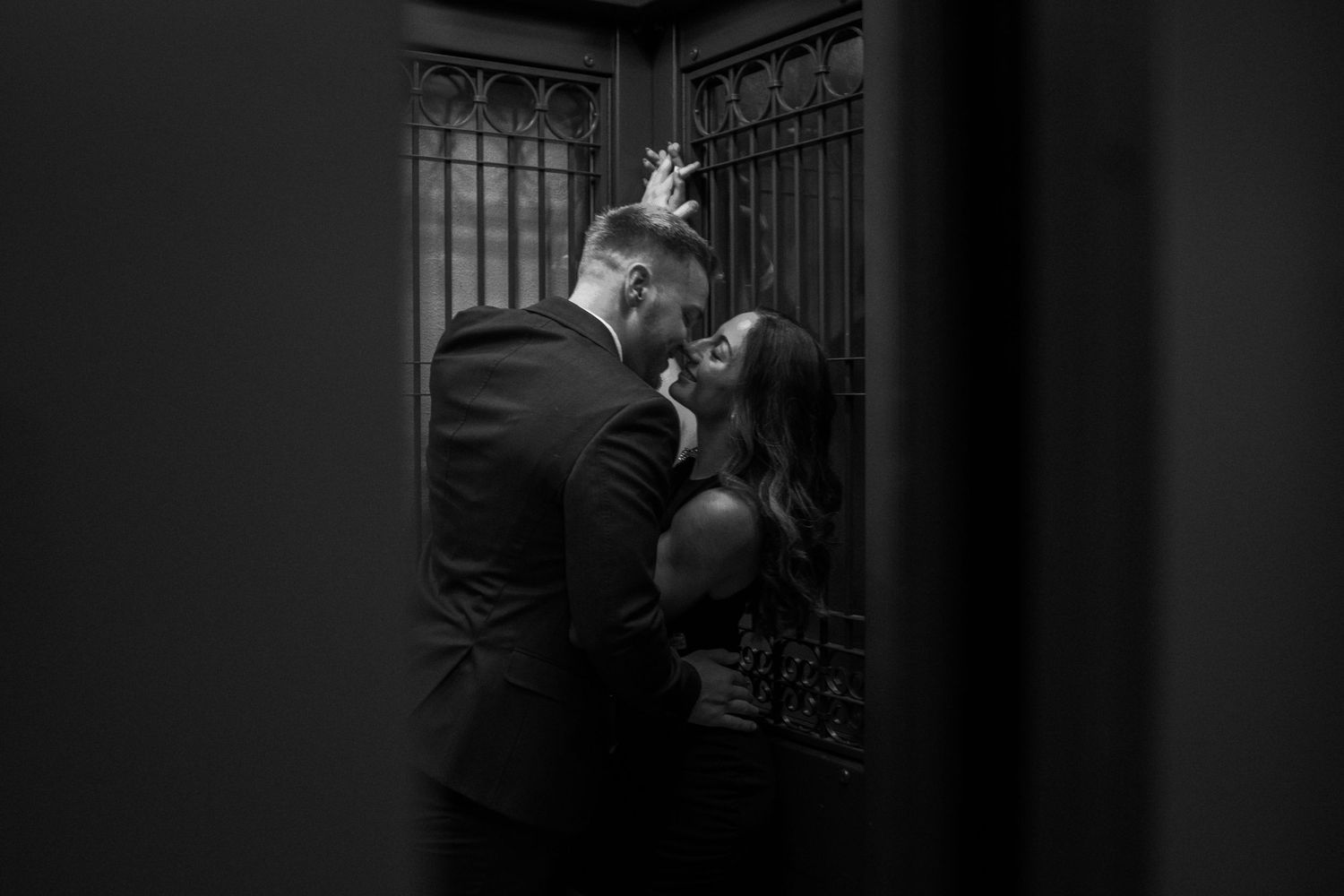 Moody black and white architectural photo featuring ornate metal railings.