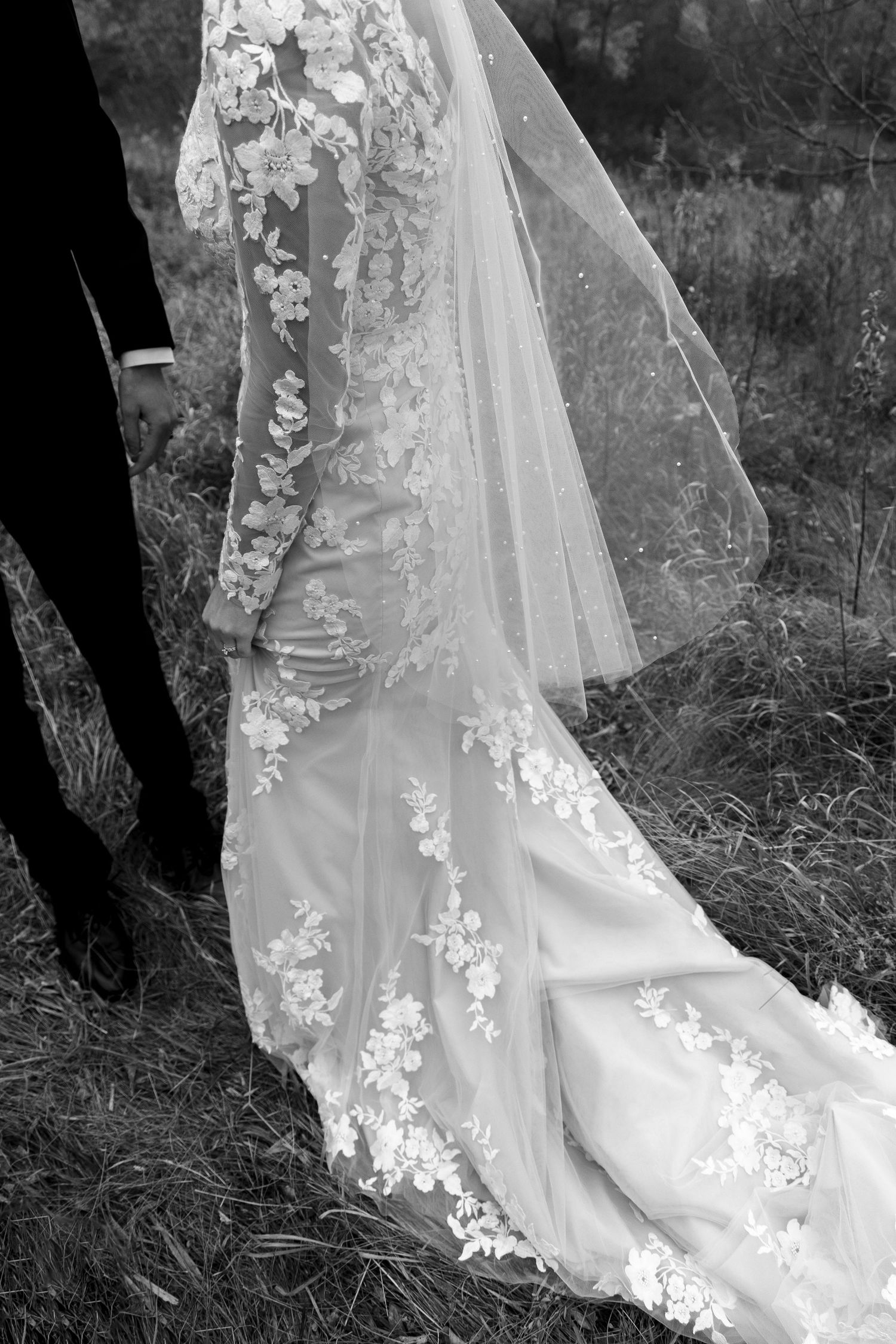 Detail shots of an elegant lace wedding dress train in black and white.