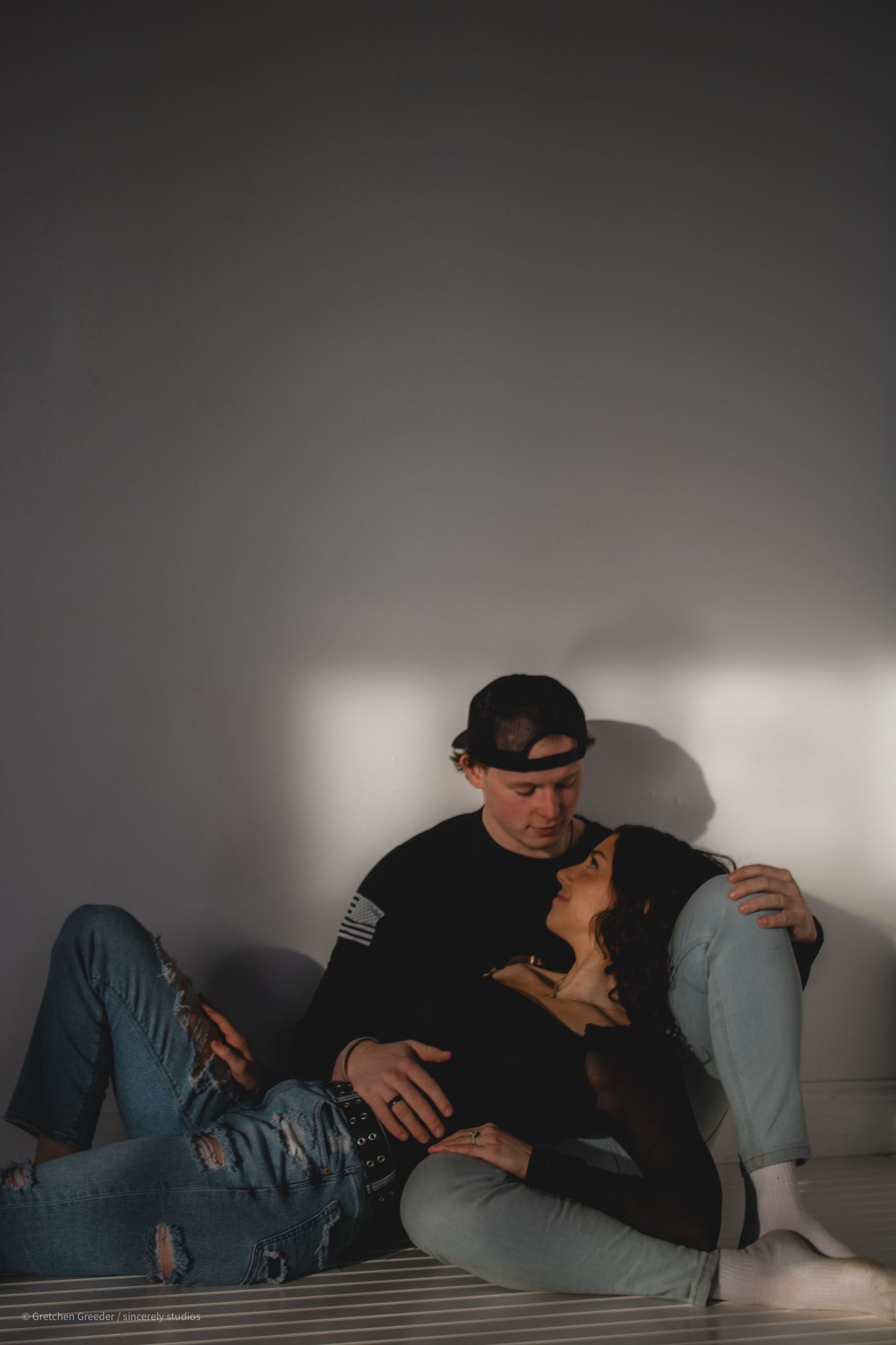 Intimate black and white portrait showing two people in casual clothing.