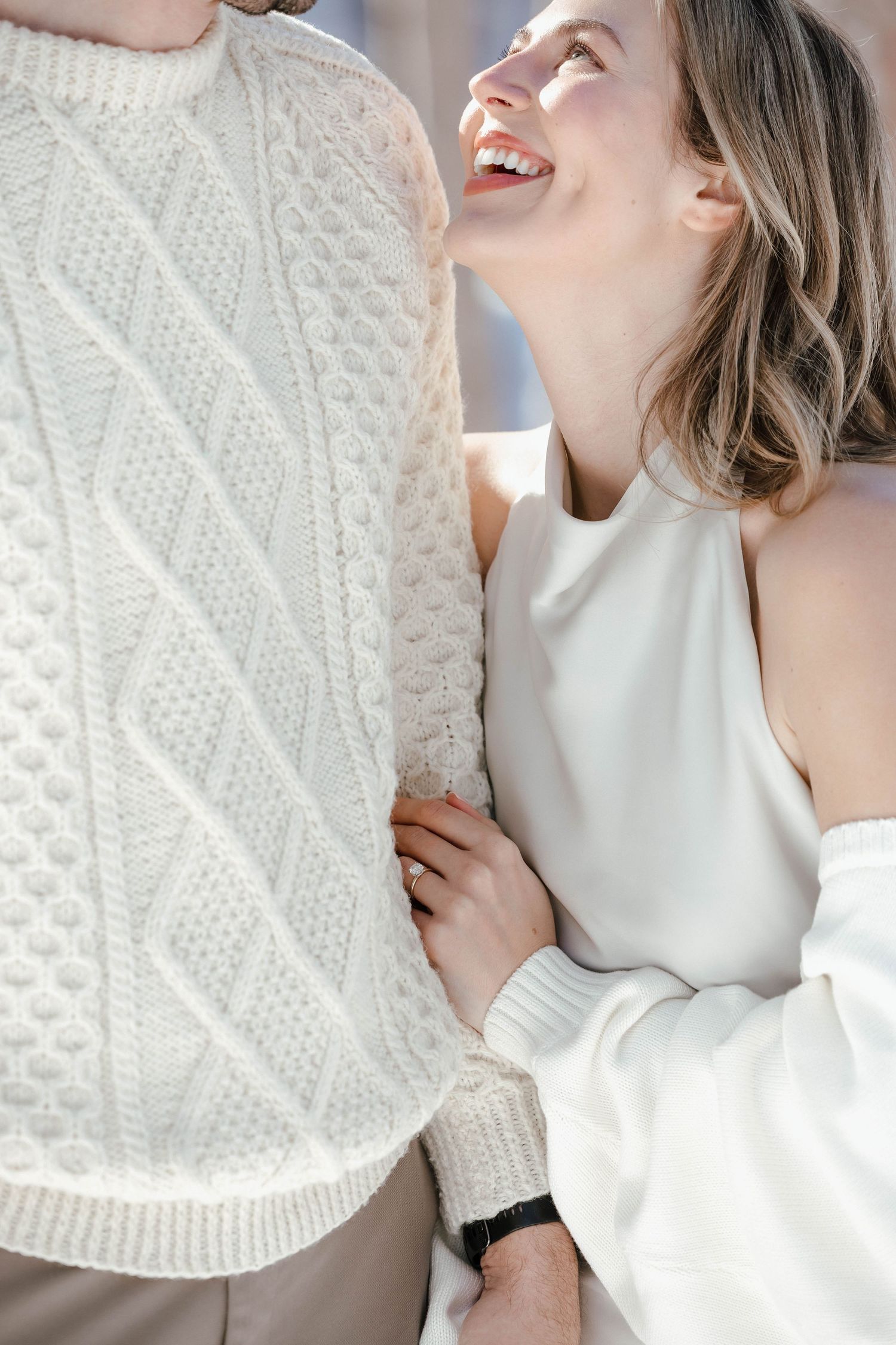 Close-up of couple sharing a tender moment wearing white winter clothing.
